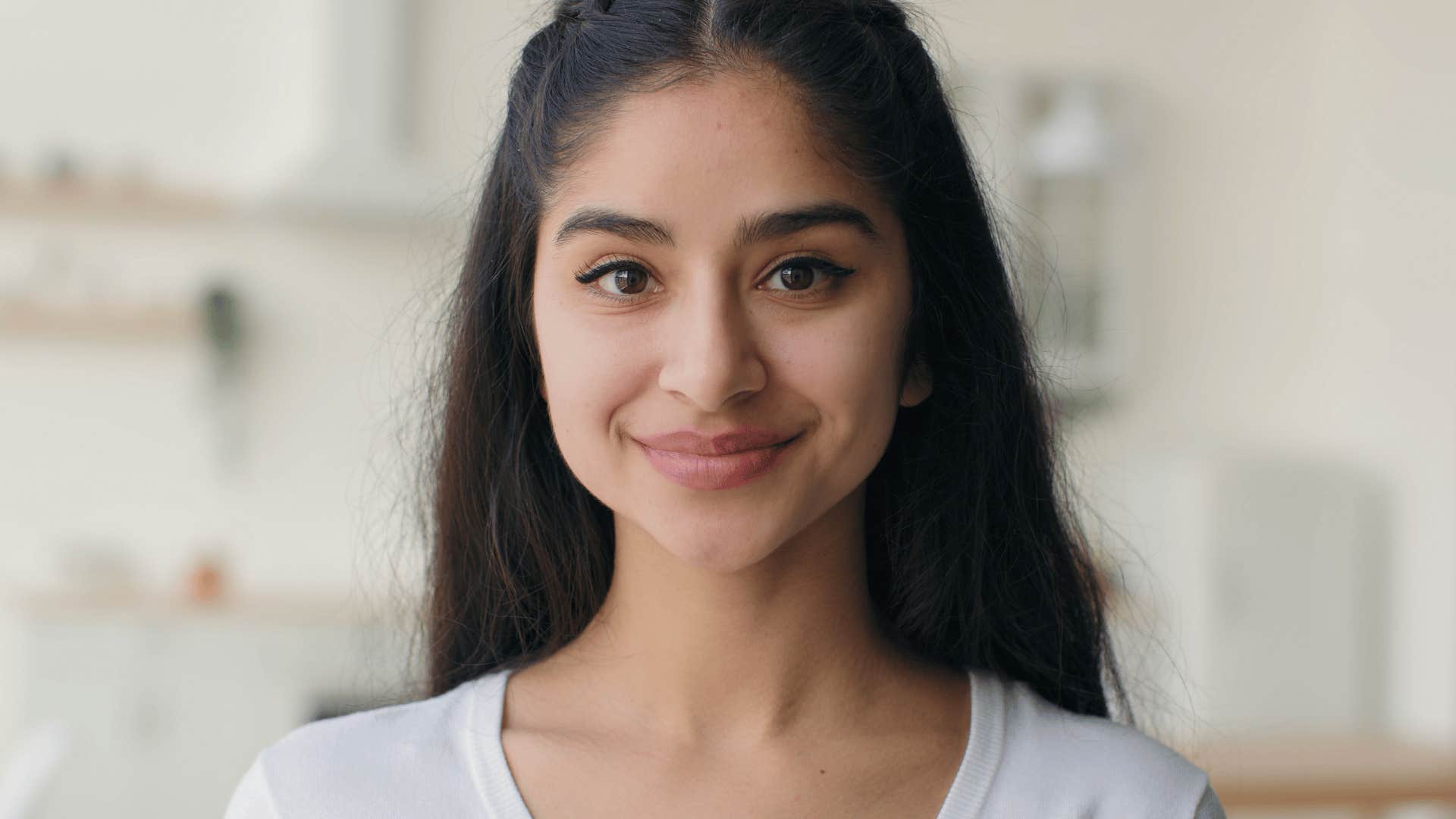 young woman smiling softly