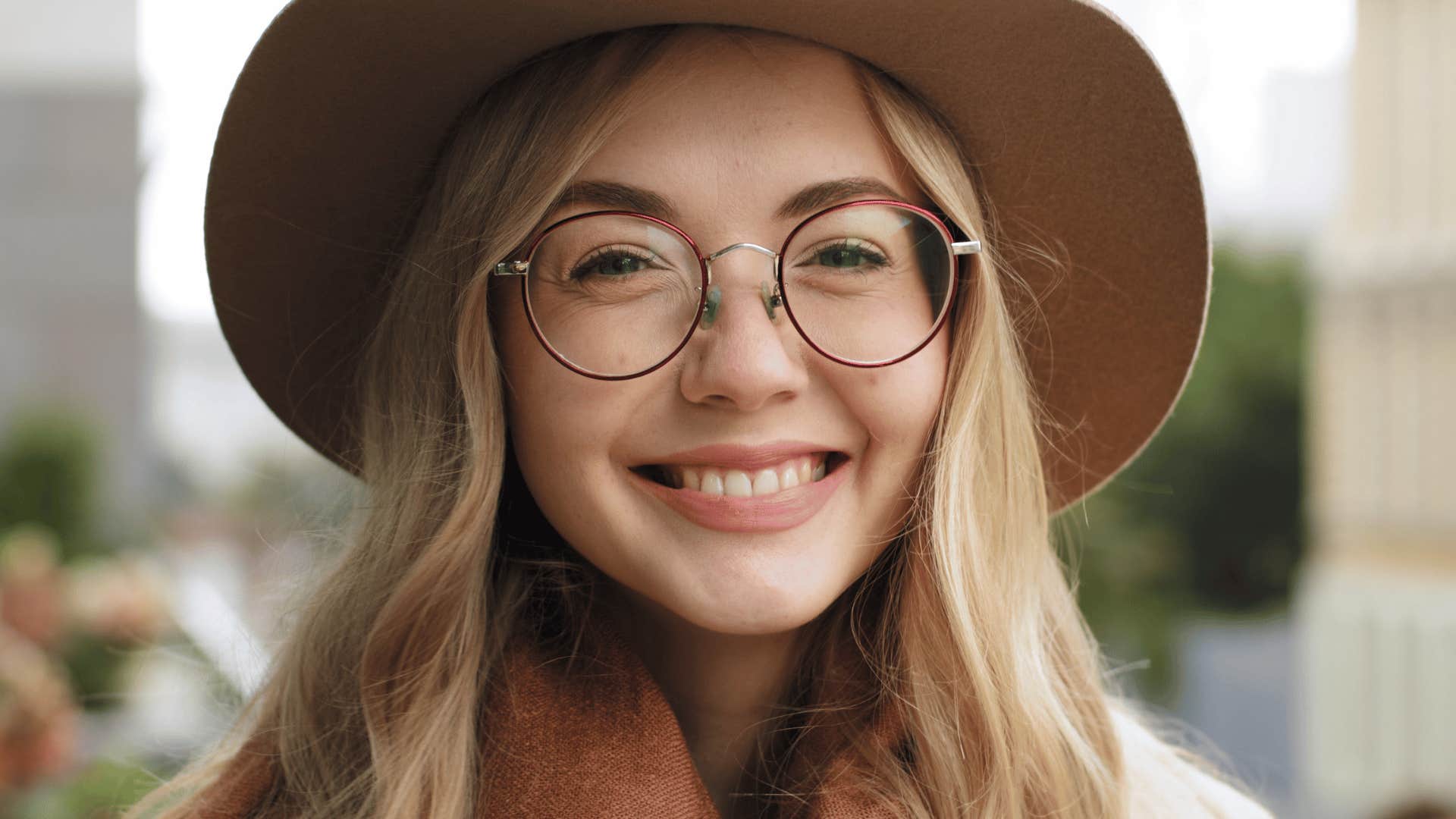 blonde young woman in brown hat