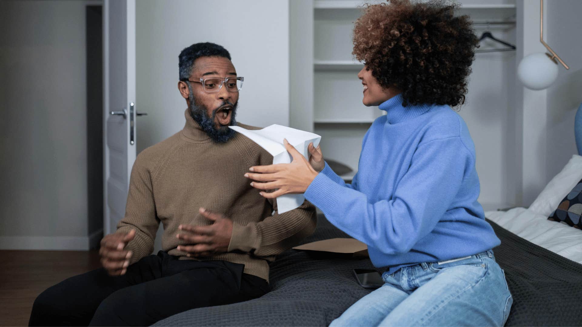 man excited about woman's acceptance letter