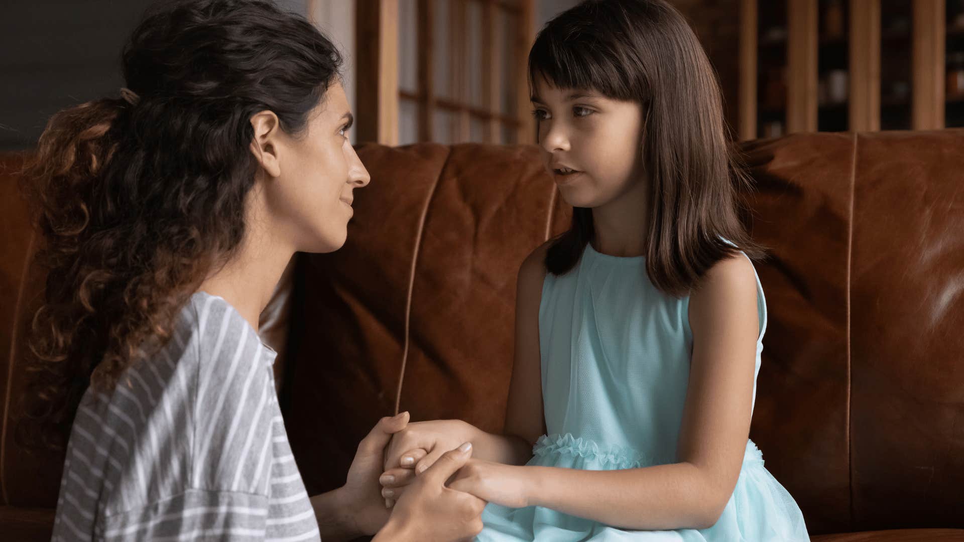 woman listening to young girl