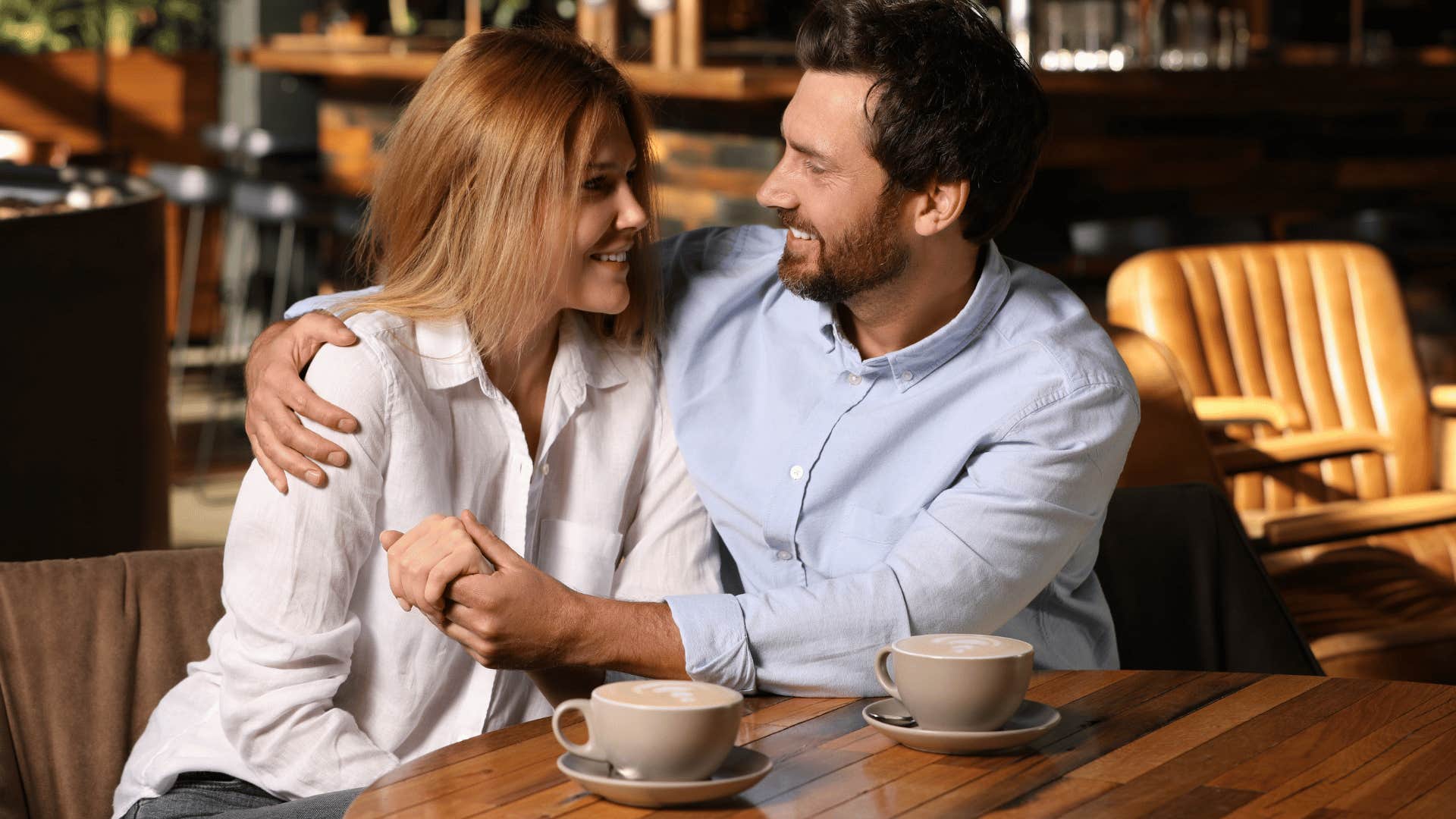 happy couple enjoying coffee outdoors