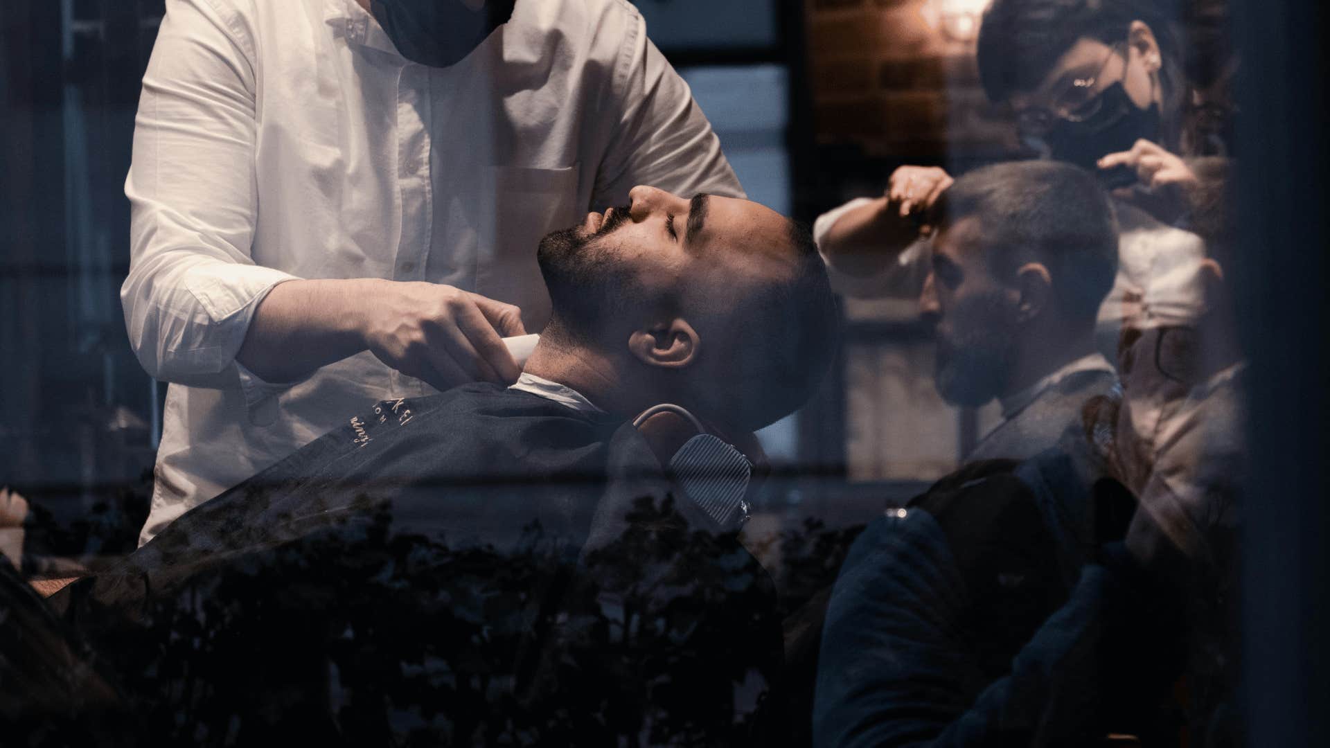 man leaning back in a barber's chair