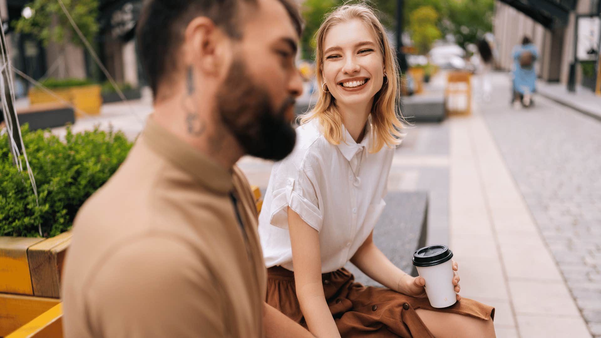 woman smiling widely at man