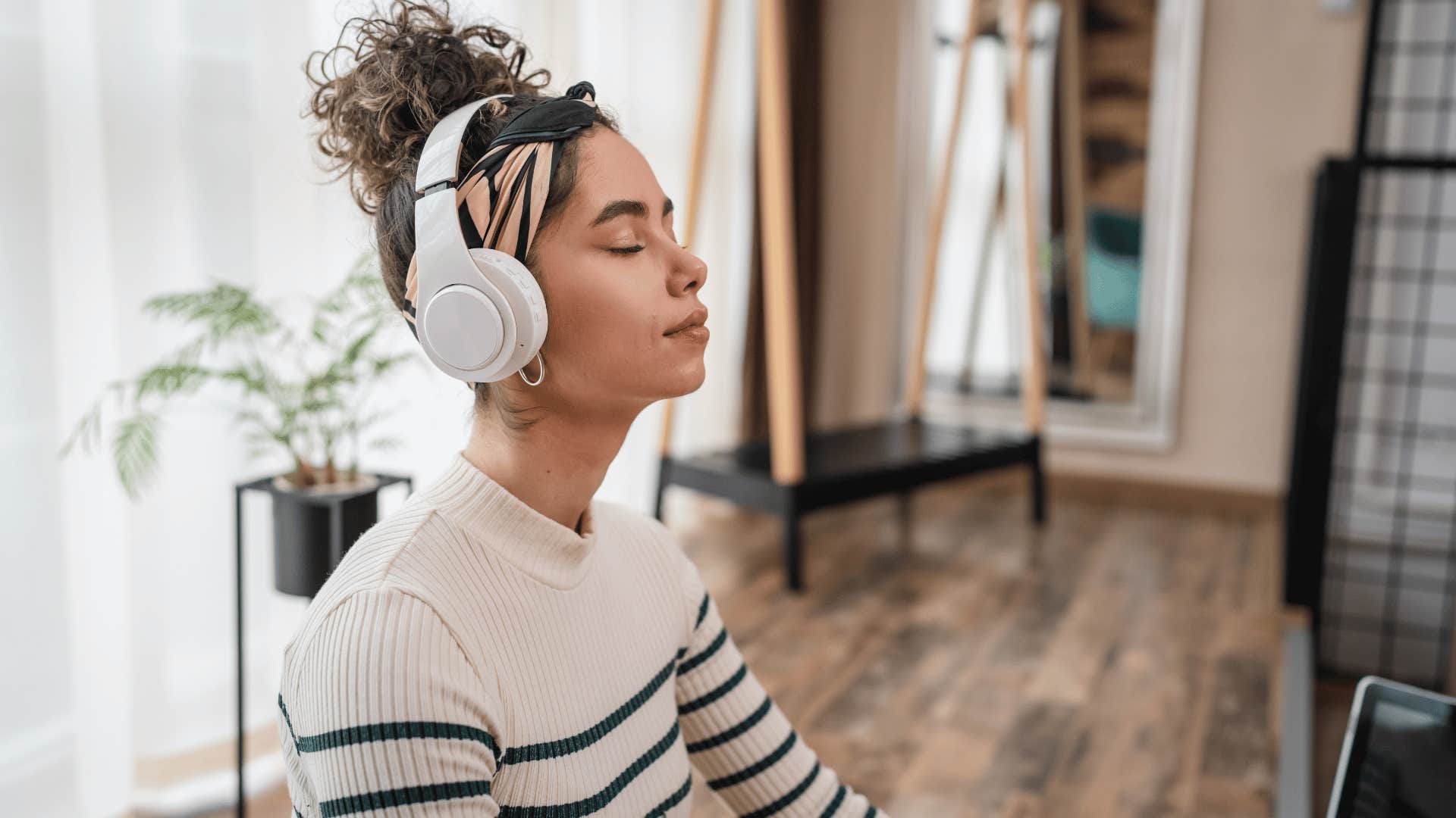 young woman wearing headphones for guided meditation