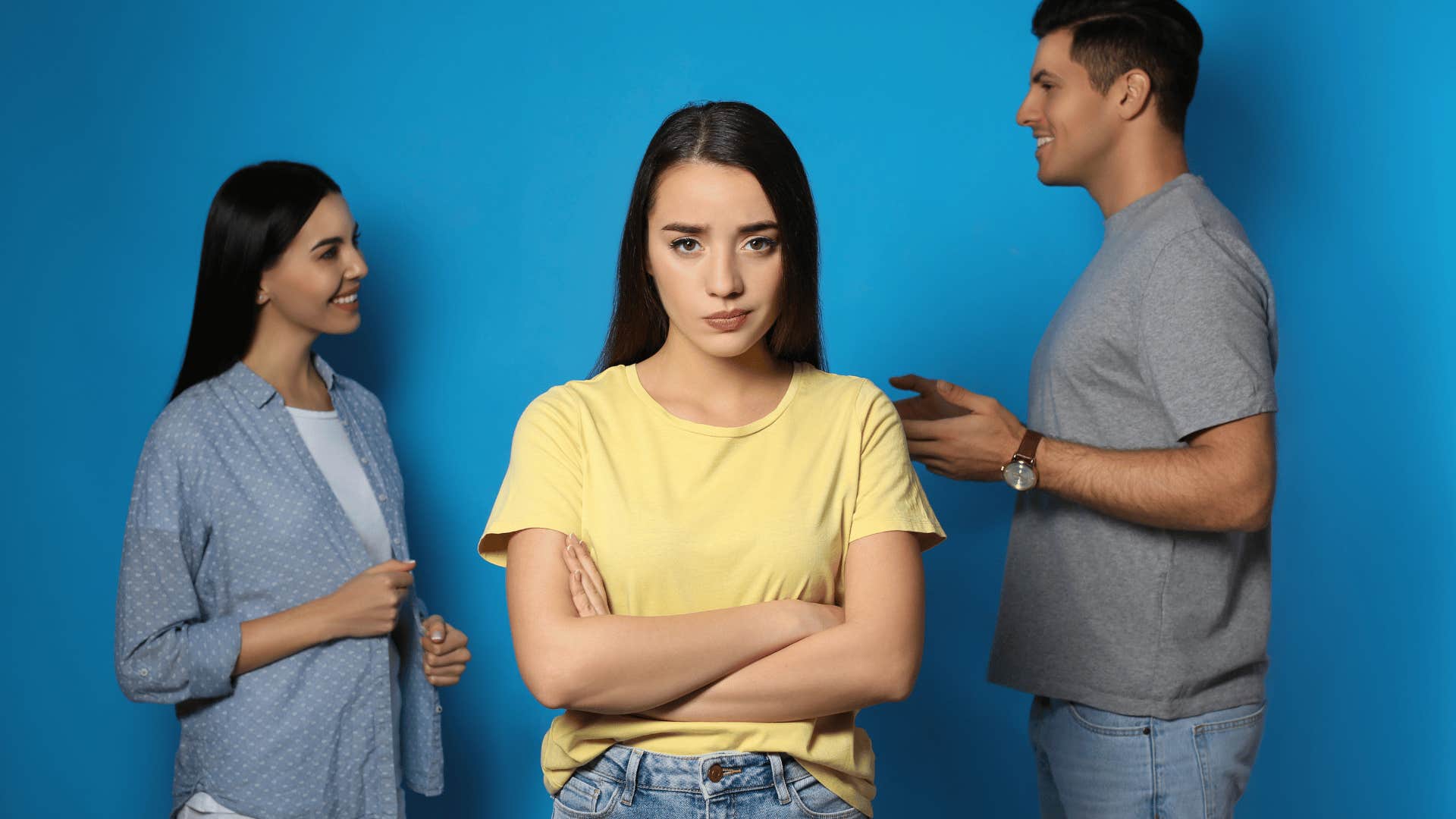 jealous woman in front of man talking to another woman