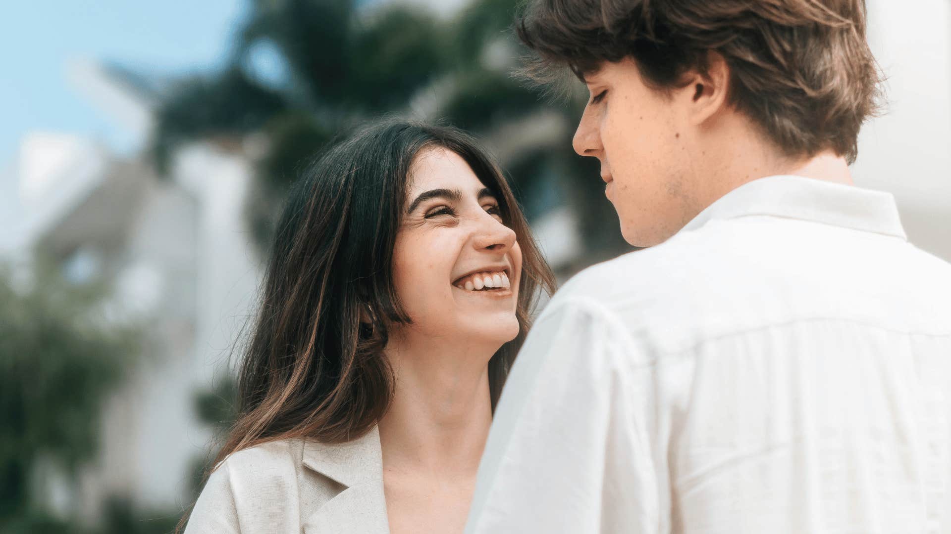 young woman smiling up at a young man