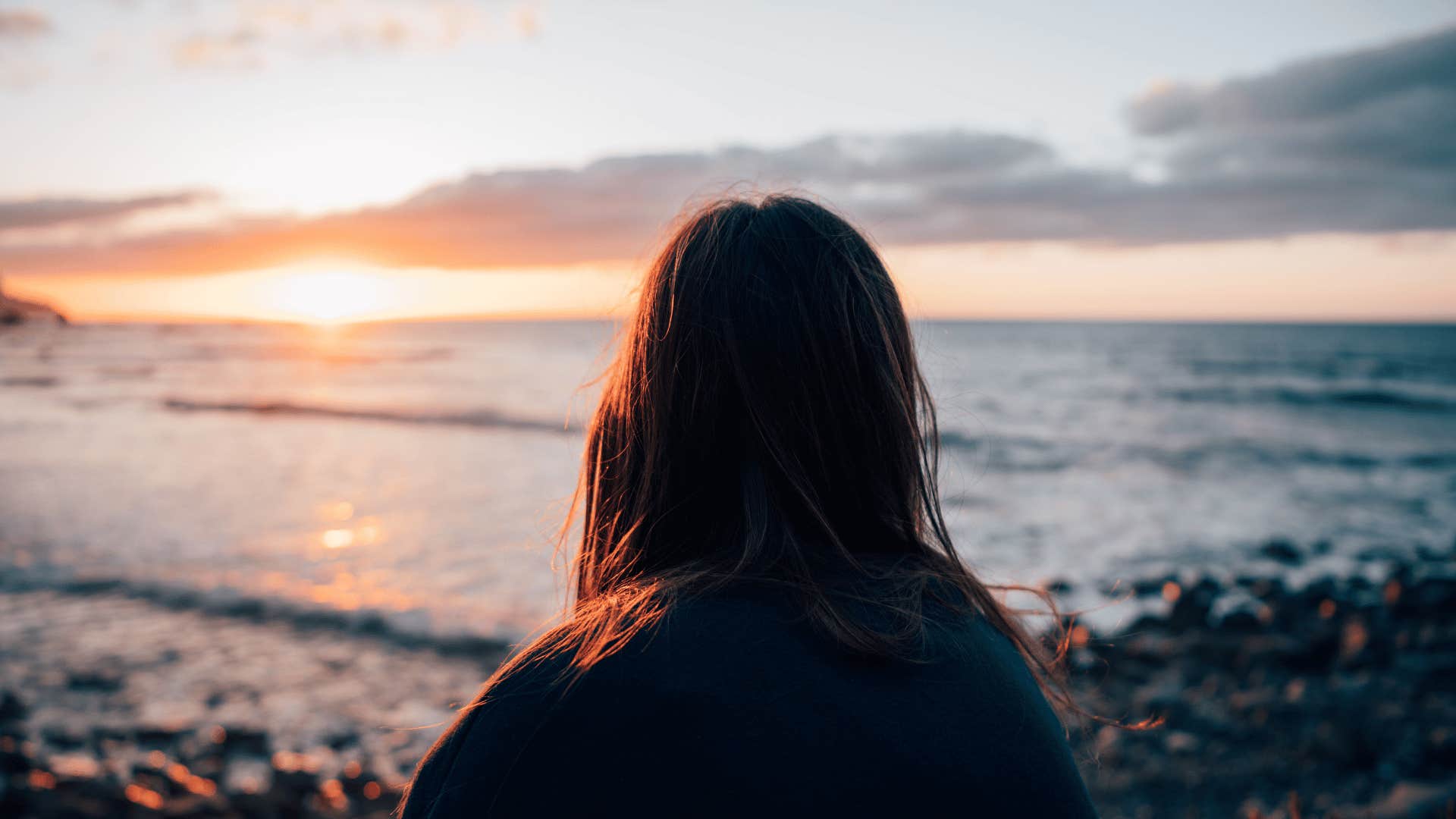 young woman watching the sunrise