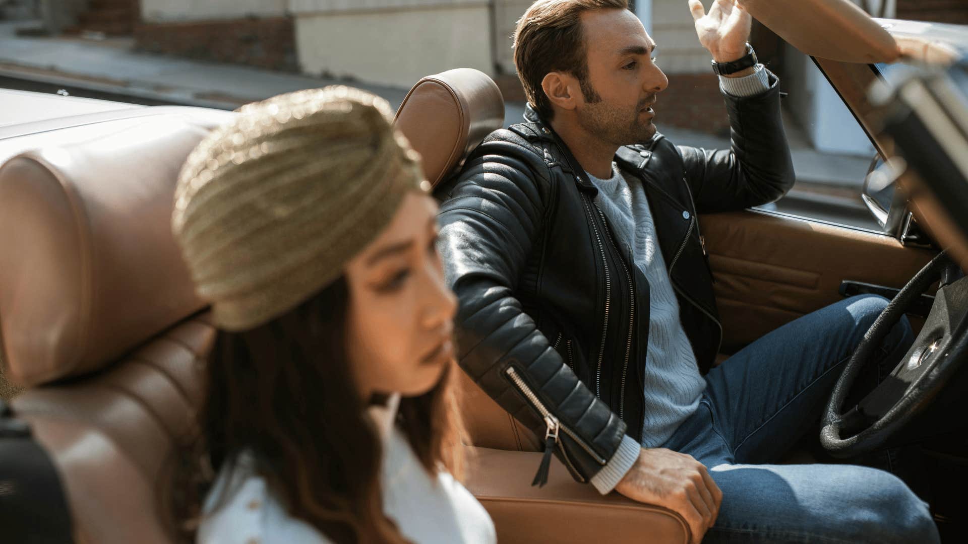 couple in car with frustrated man