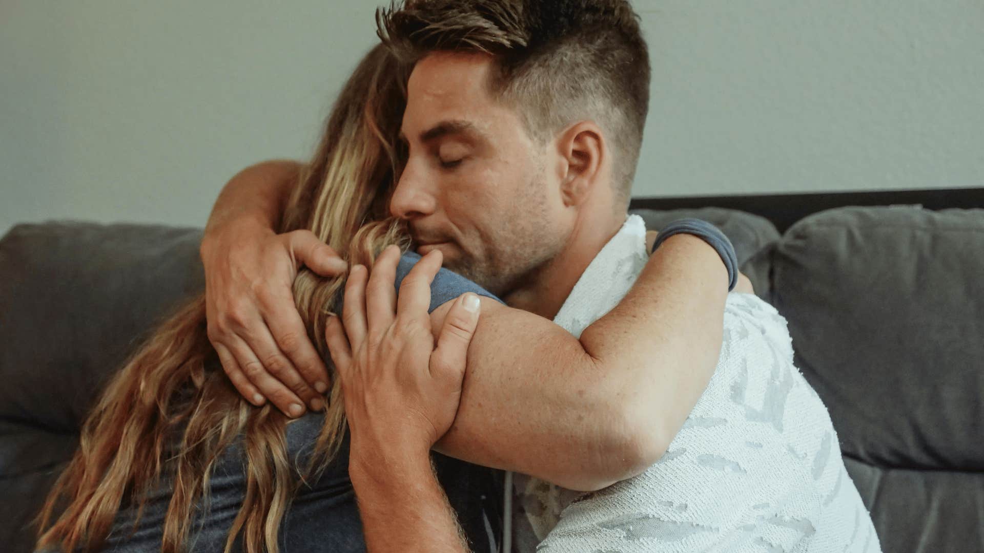 man hugging woman back