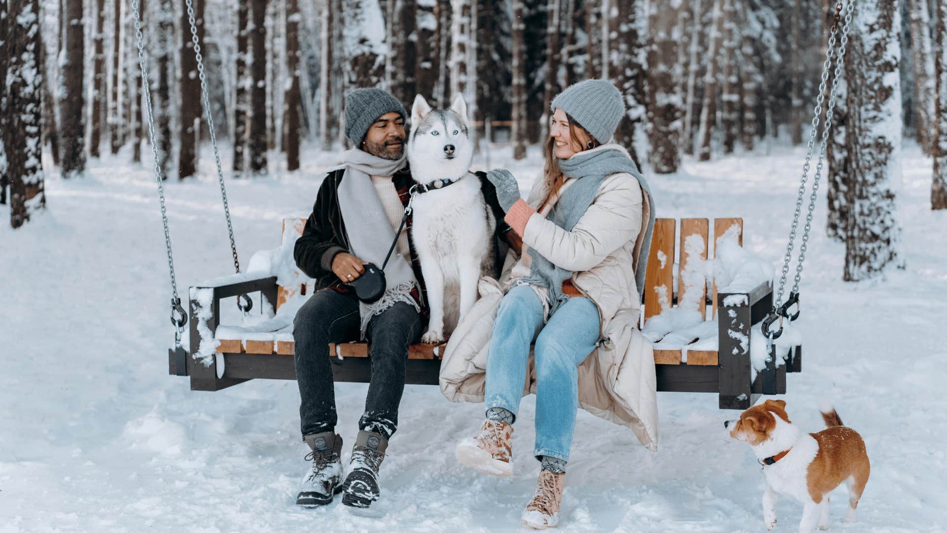 couple sitting on a bench swing during winter