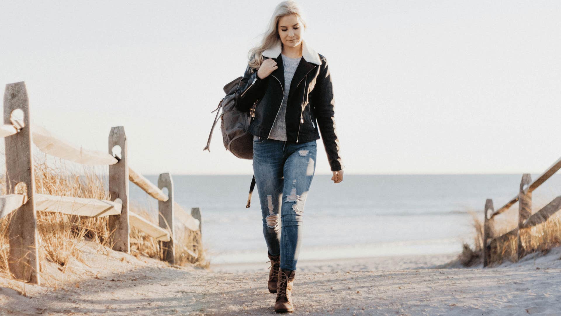 woman in a leather jacket on a walking path