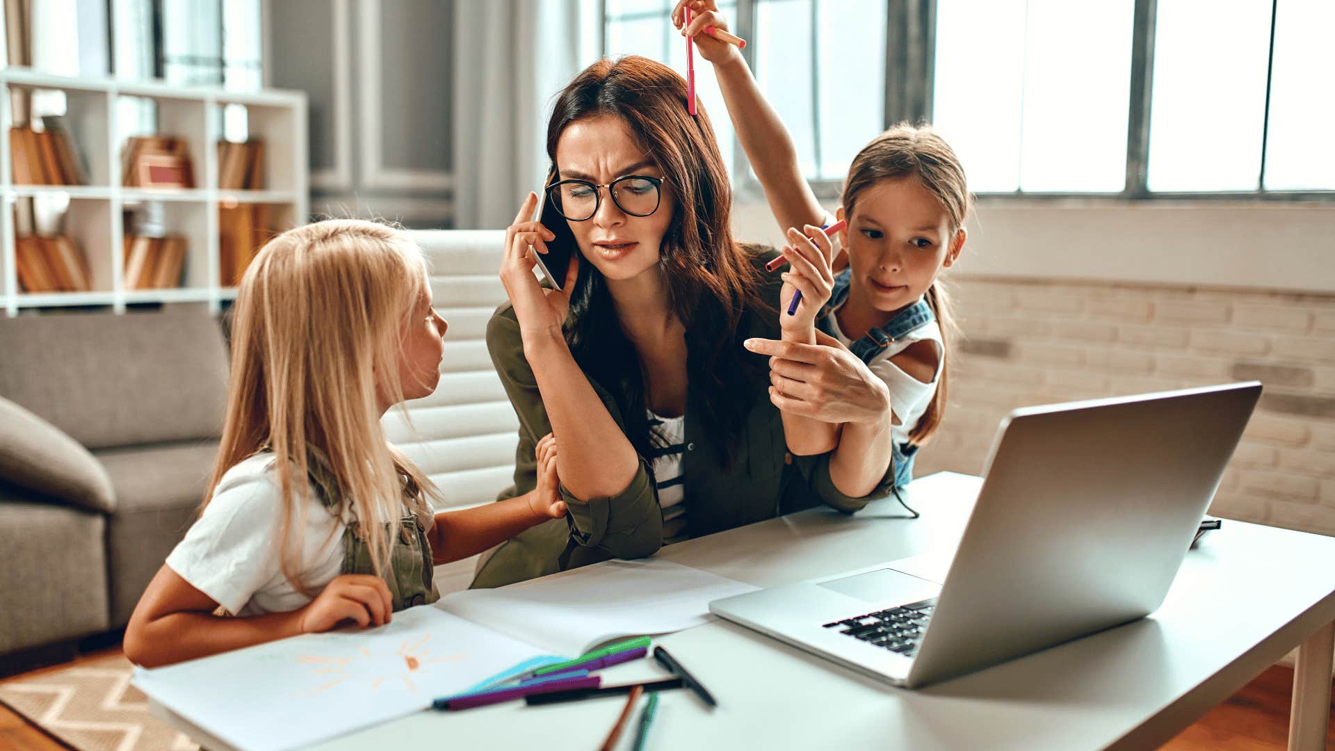 woman on the phone distracted by kids