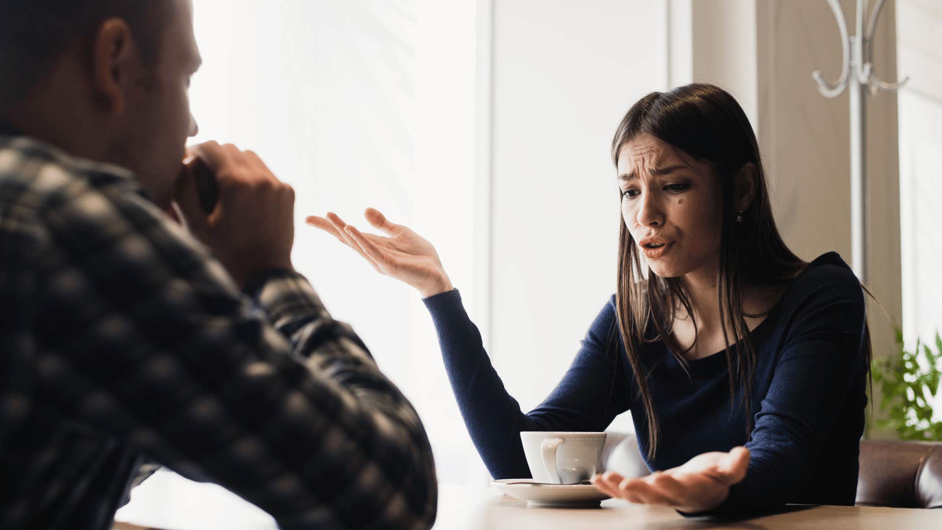 young couple arguing in a cafe