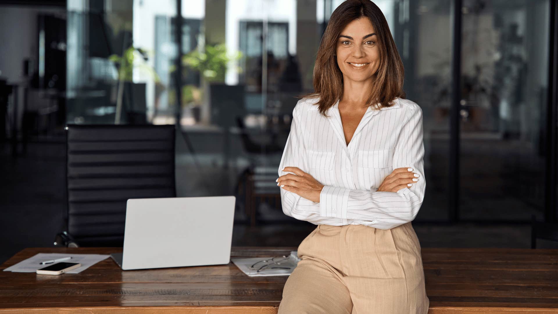 professional woman leaning desk