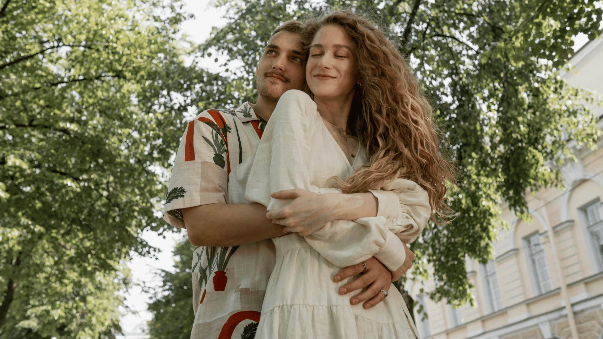 man hugging woman close from behind