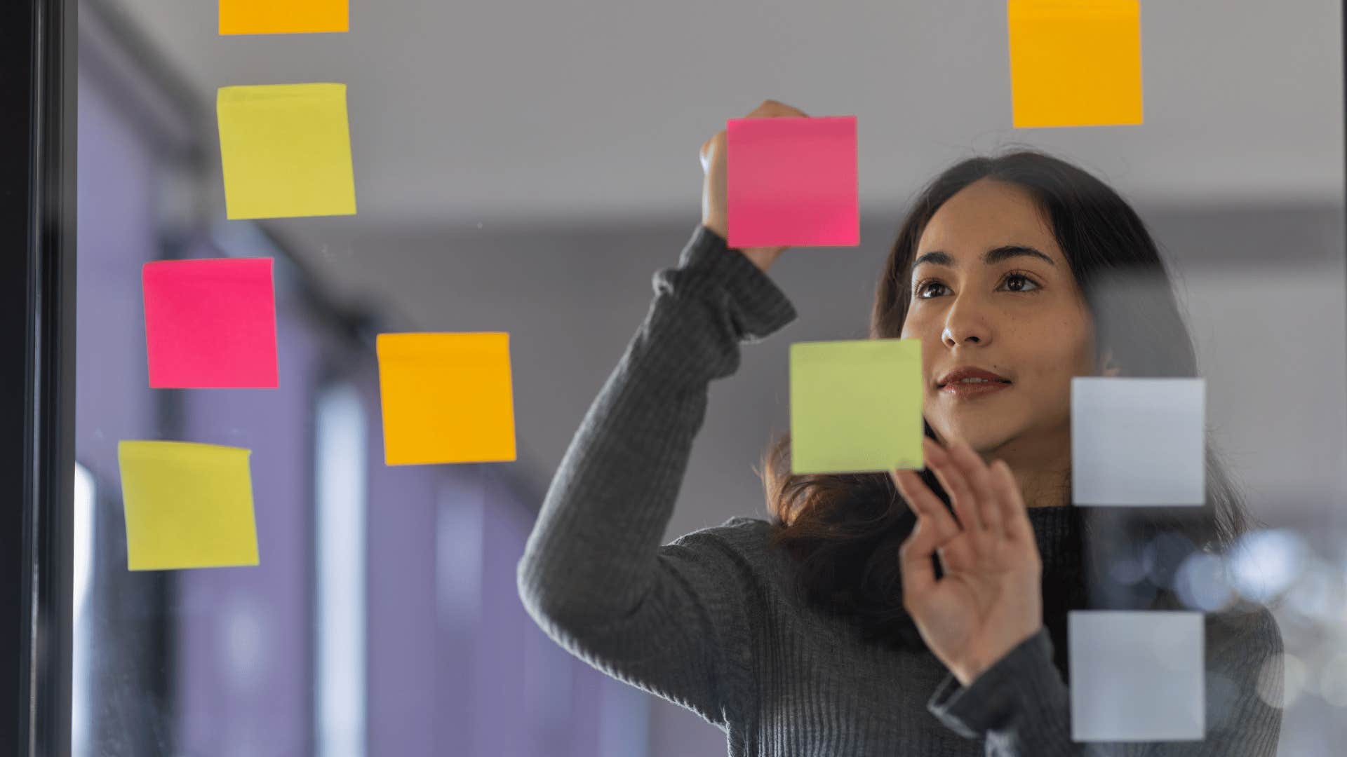 professional woman arranging sticky notes