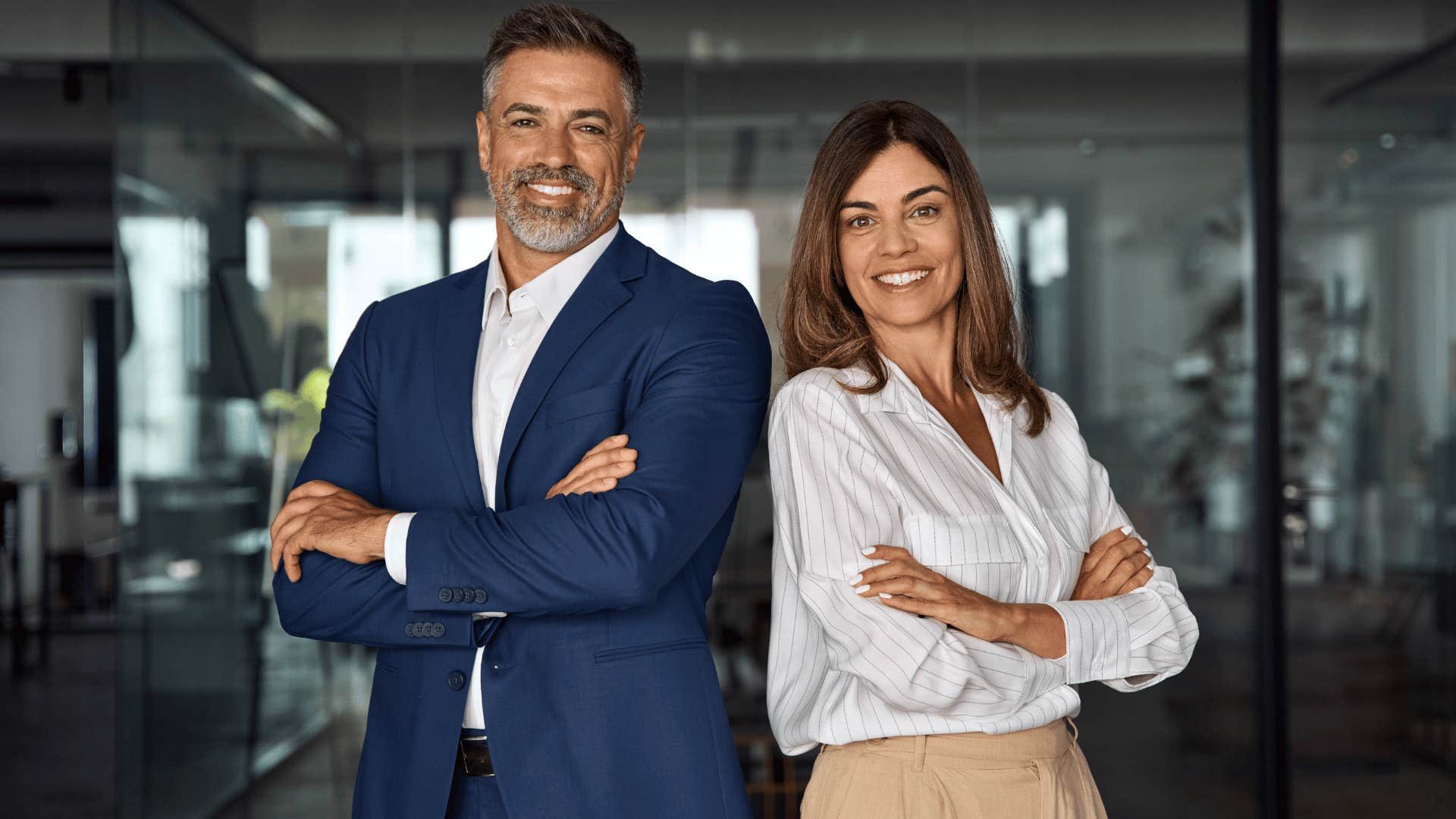 two smiling professionals standing together