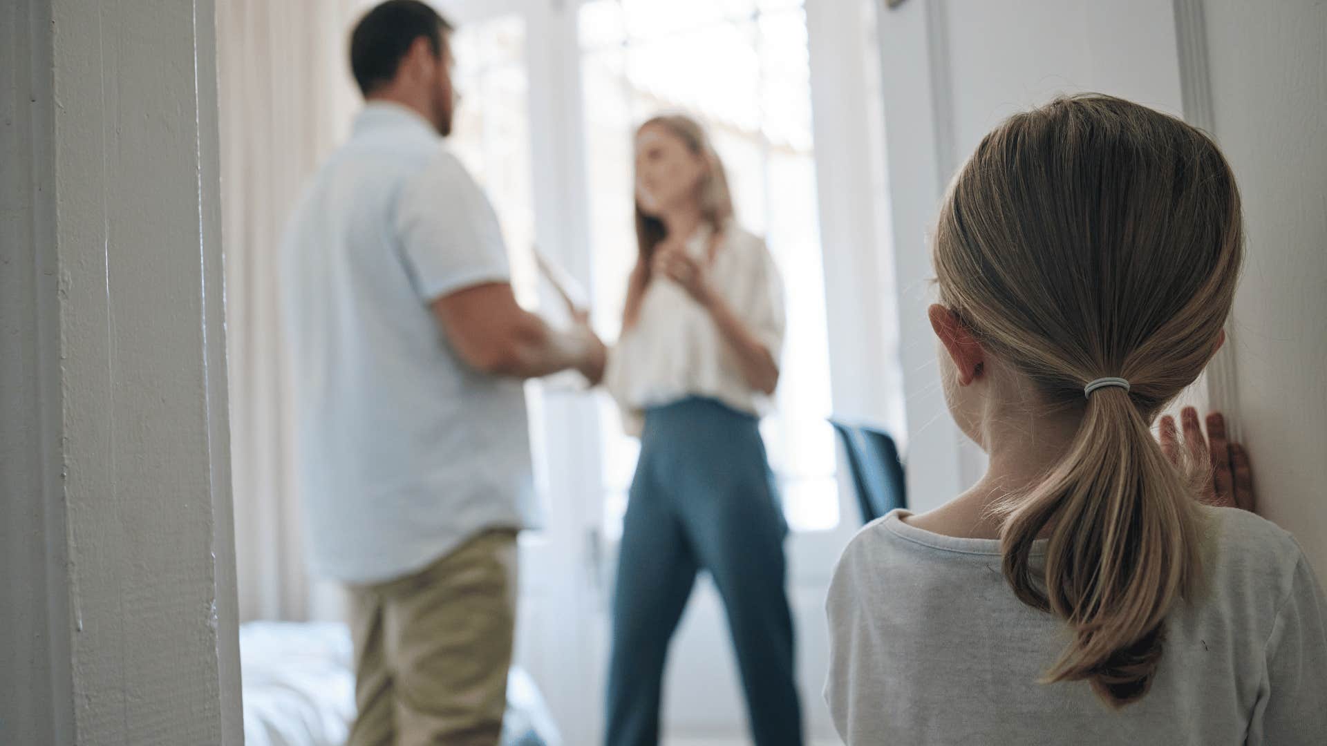 young girl watching parents arguing