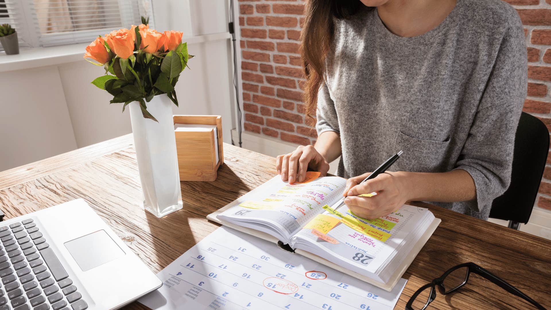 woman writing in a planning agenda