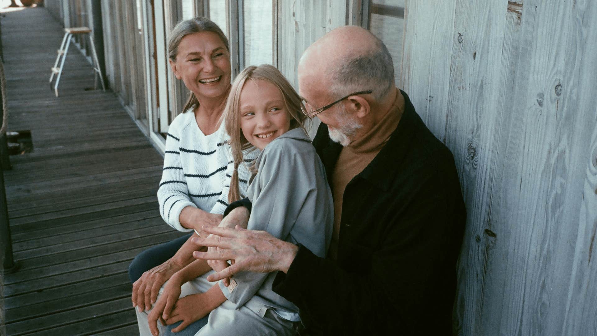 young girl sitting with her grandparents