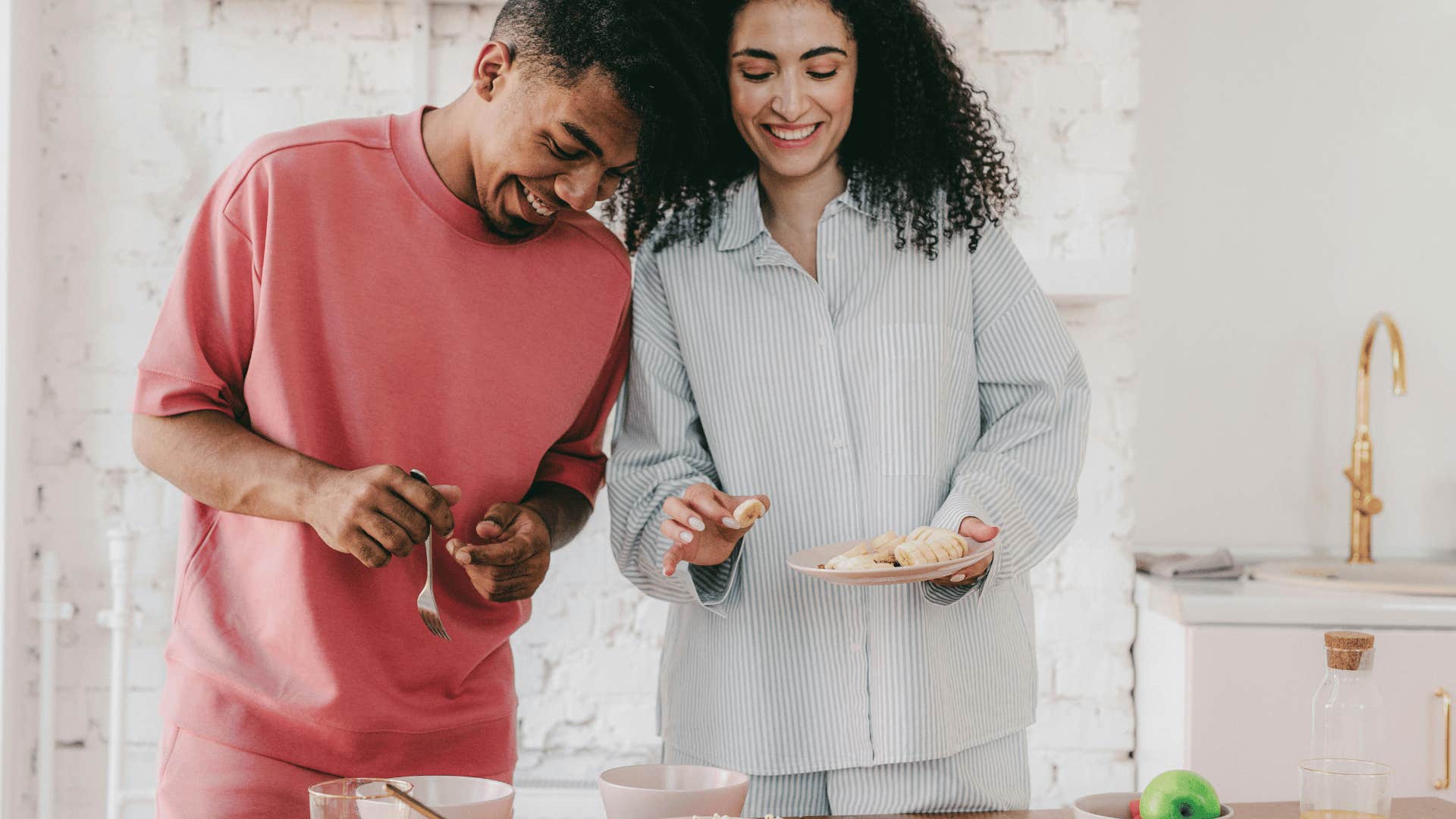 man and woman eating breakfast together