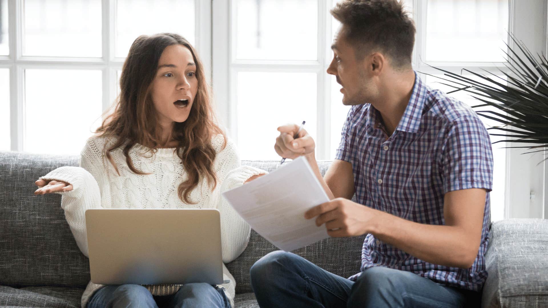 upset man confronting confused woman