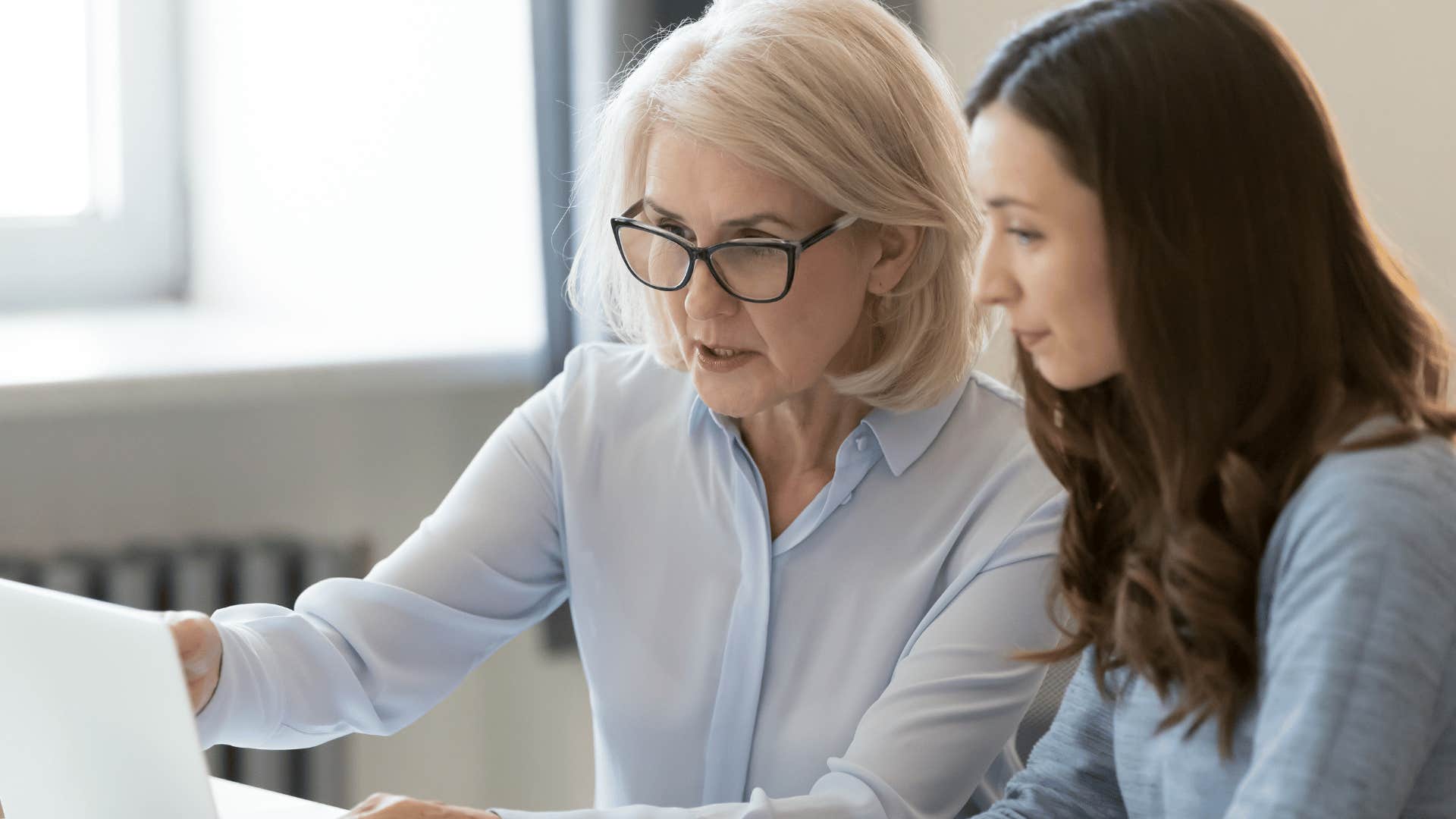 young woman listening to guidance from older woman