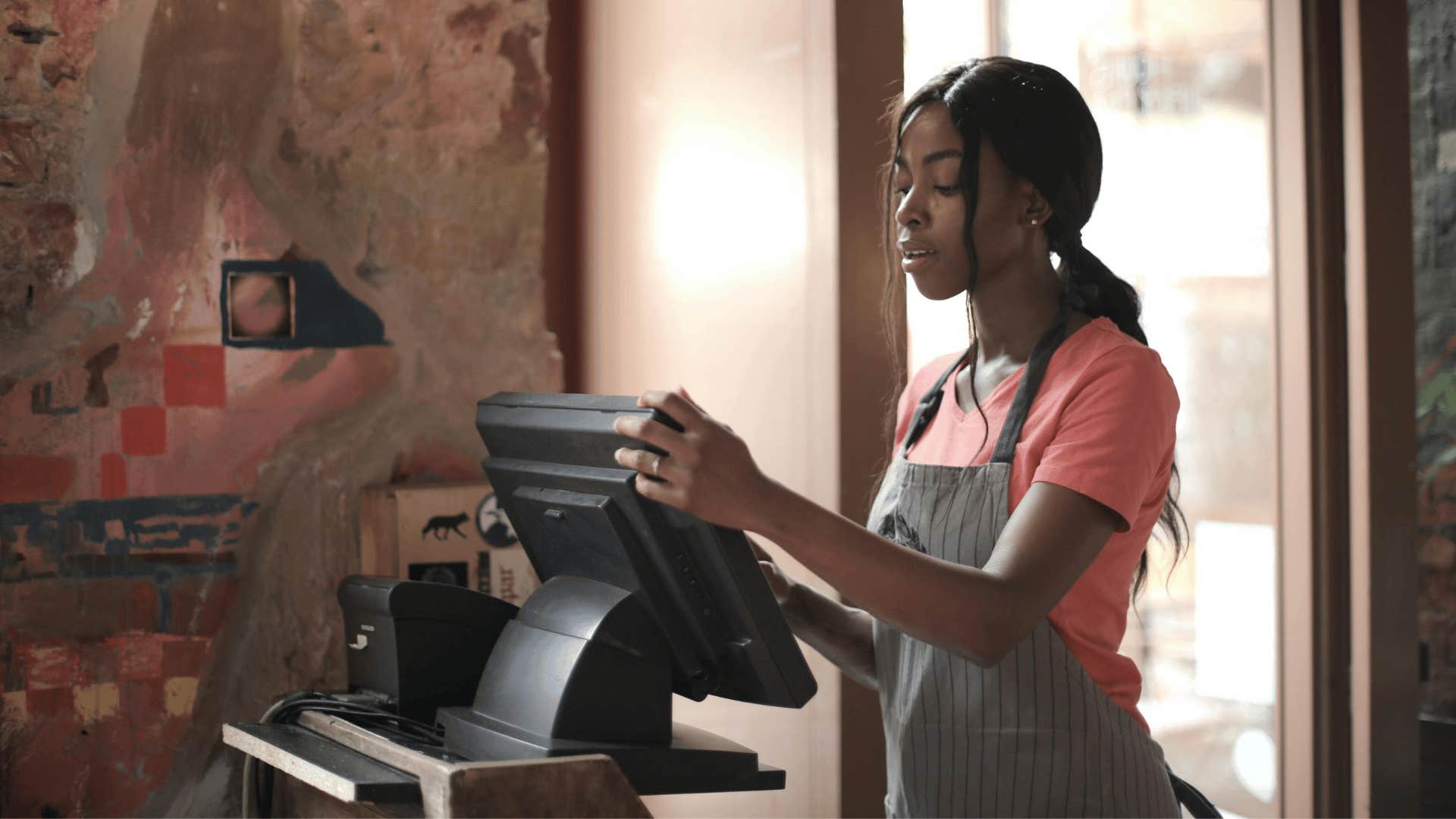 young woman working as a cashier