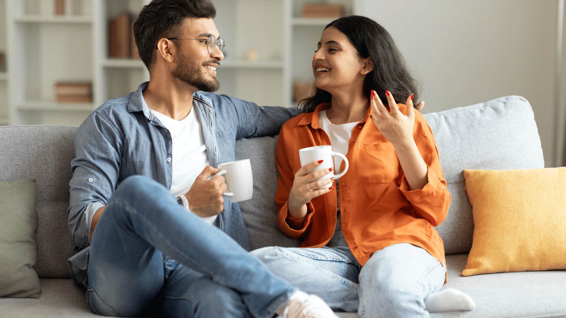 happy couple talking on a couch