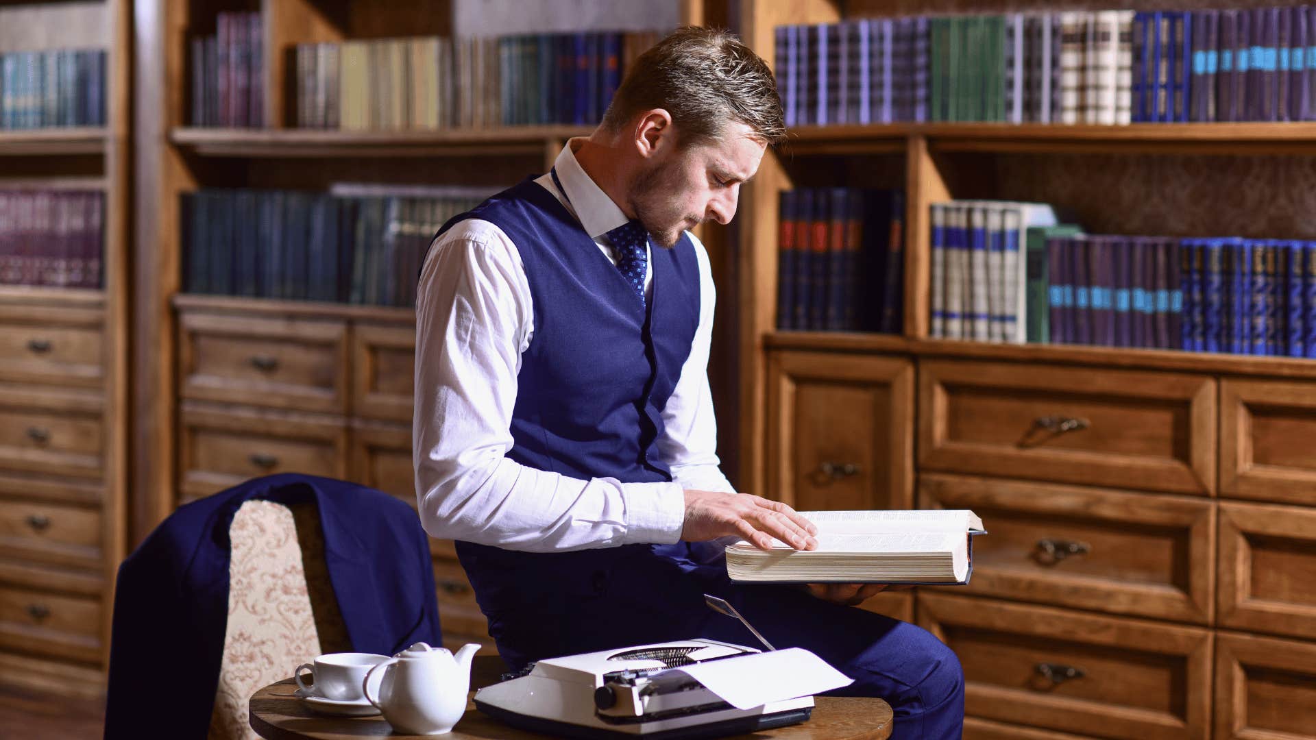 educated man reading through a book