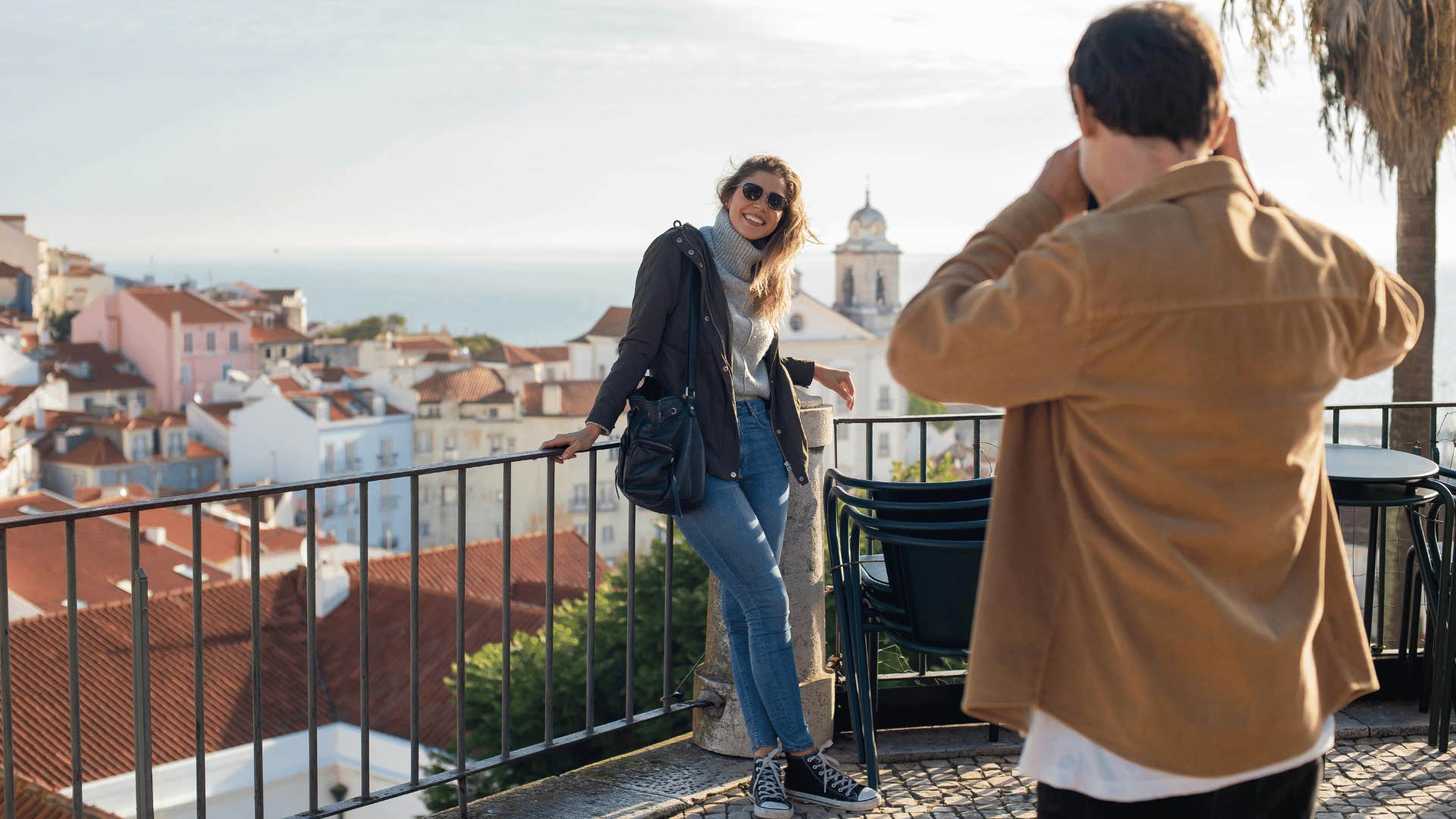 man taking a photo of a smiling woman