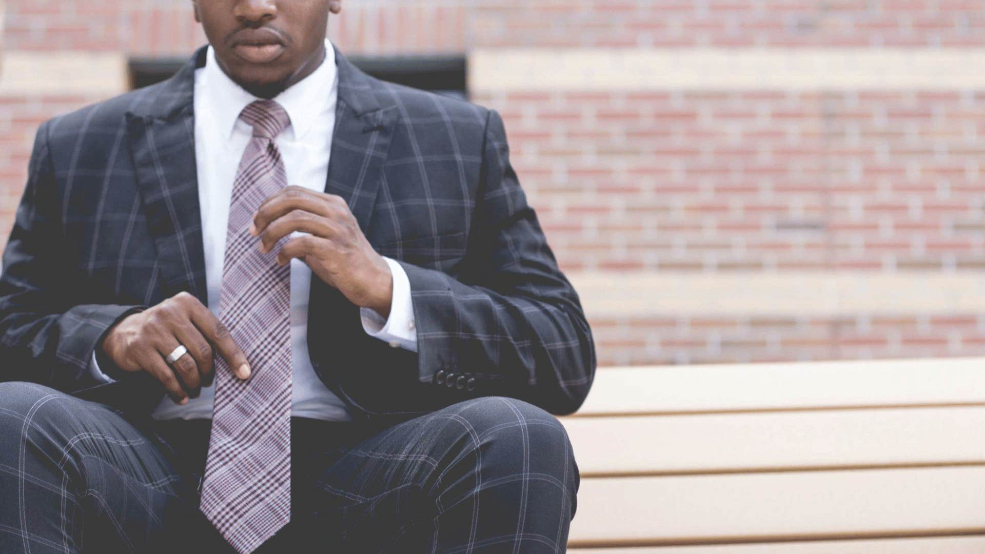 professional man readjusting his tie