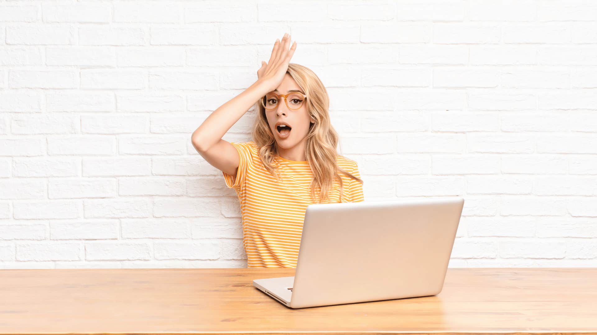 young woman raising her palm to her forehead