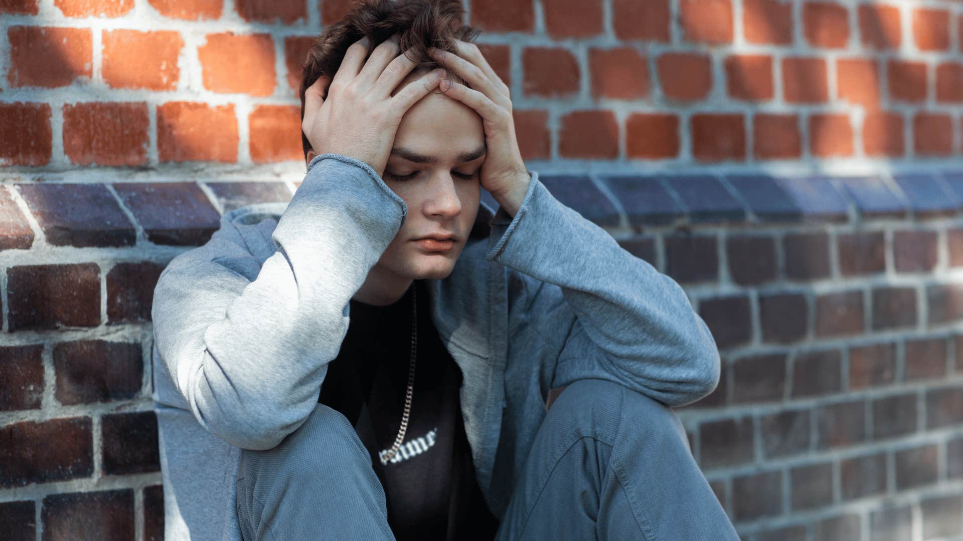 disappointed young man sitting on the ground