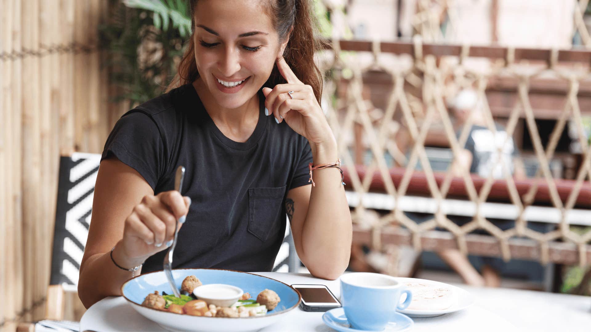 happy woman enjoying a meal alone