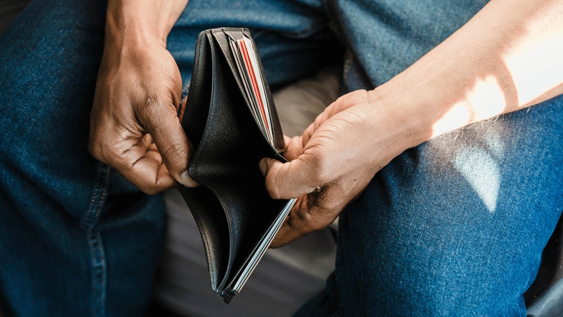 man showing his empty wallet