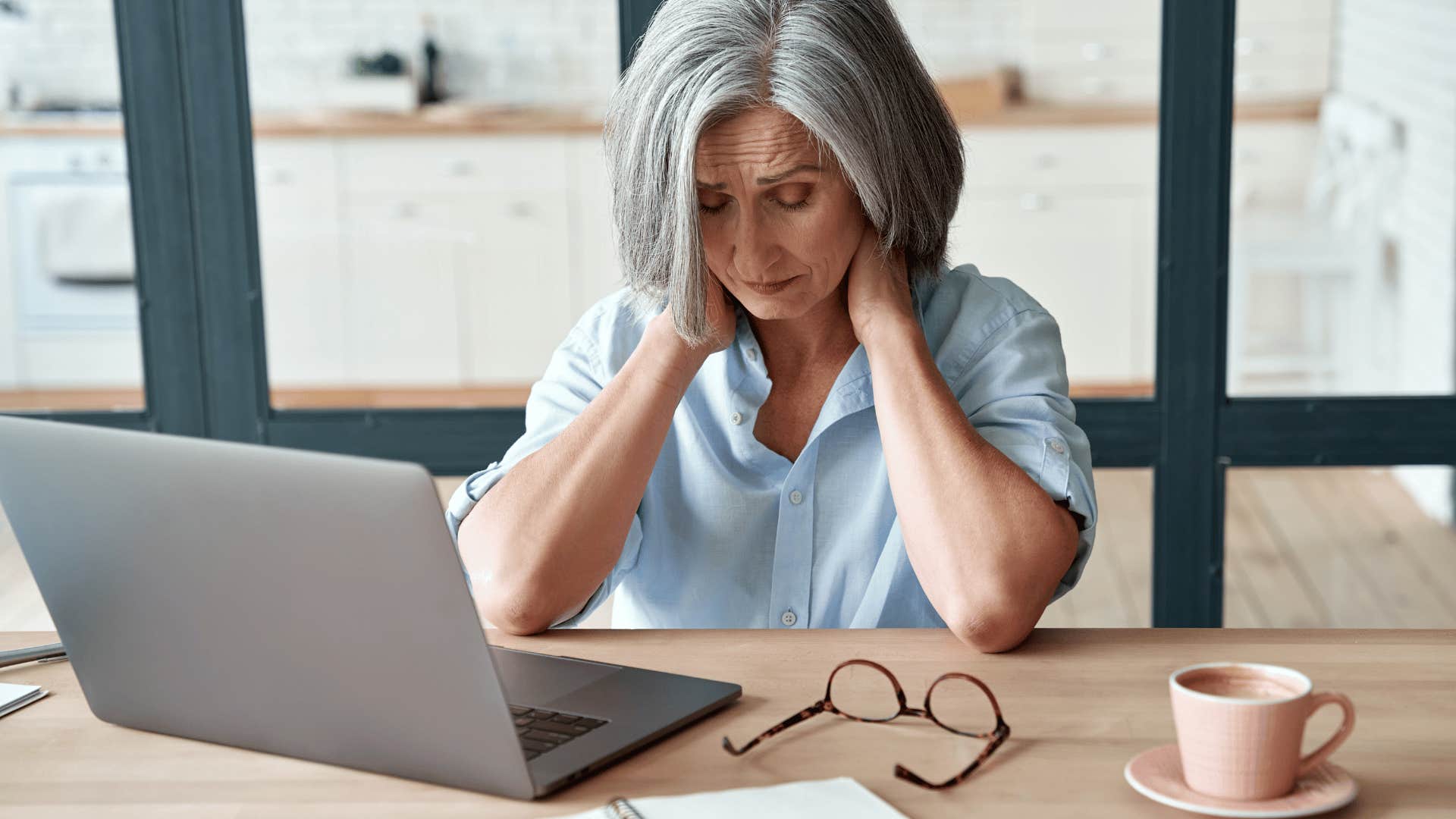 older woman massaging her neck