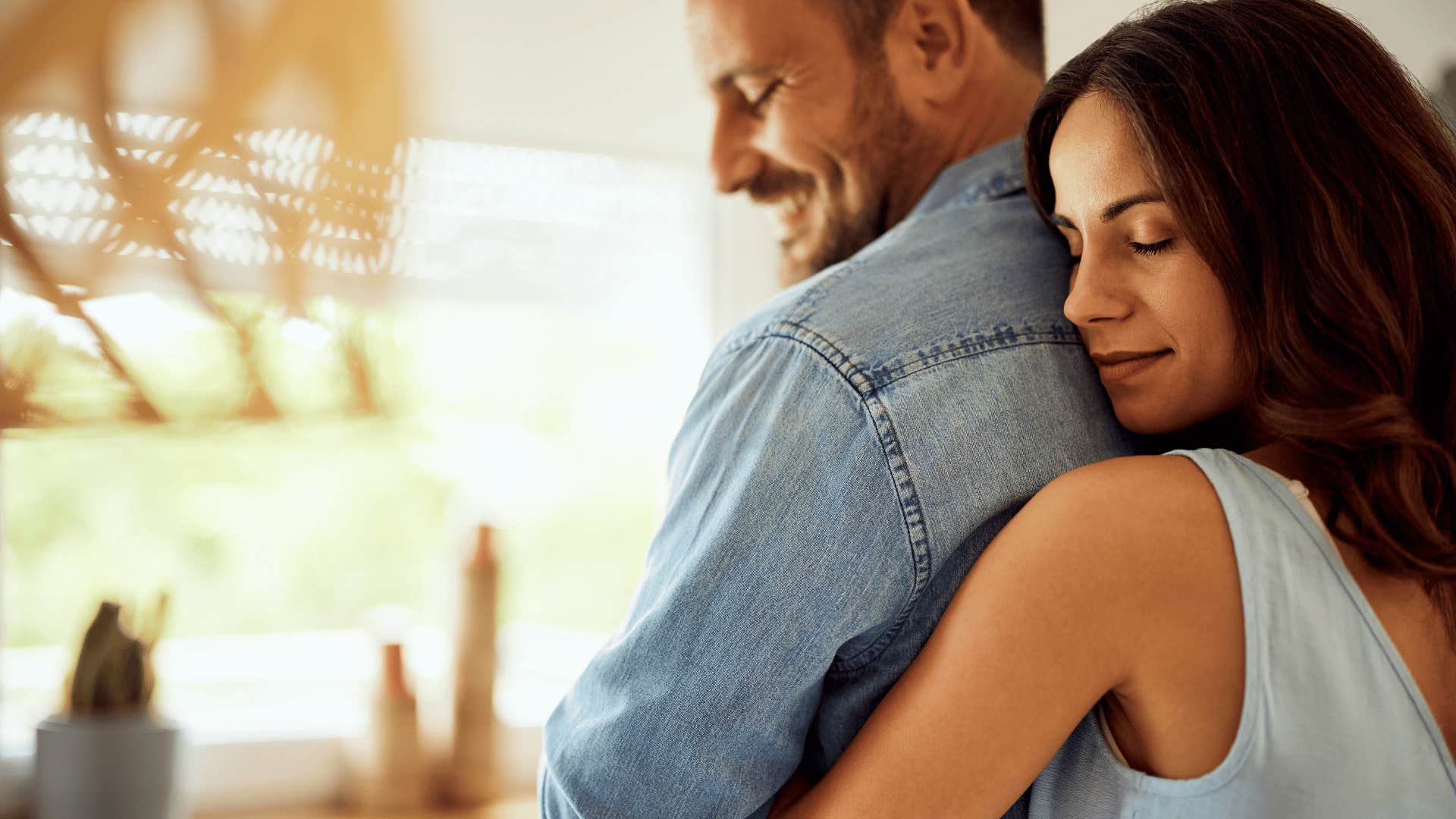 sweet woman hugging a man from behind