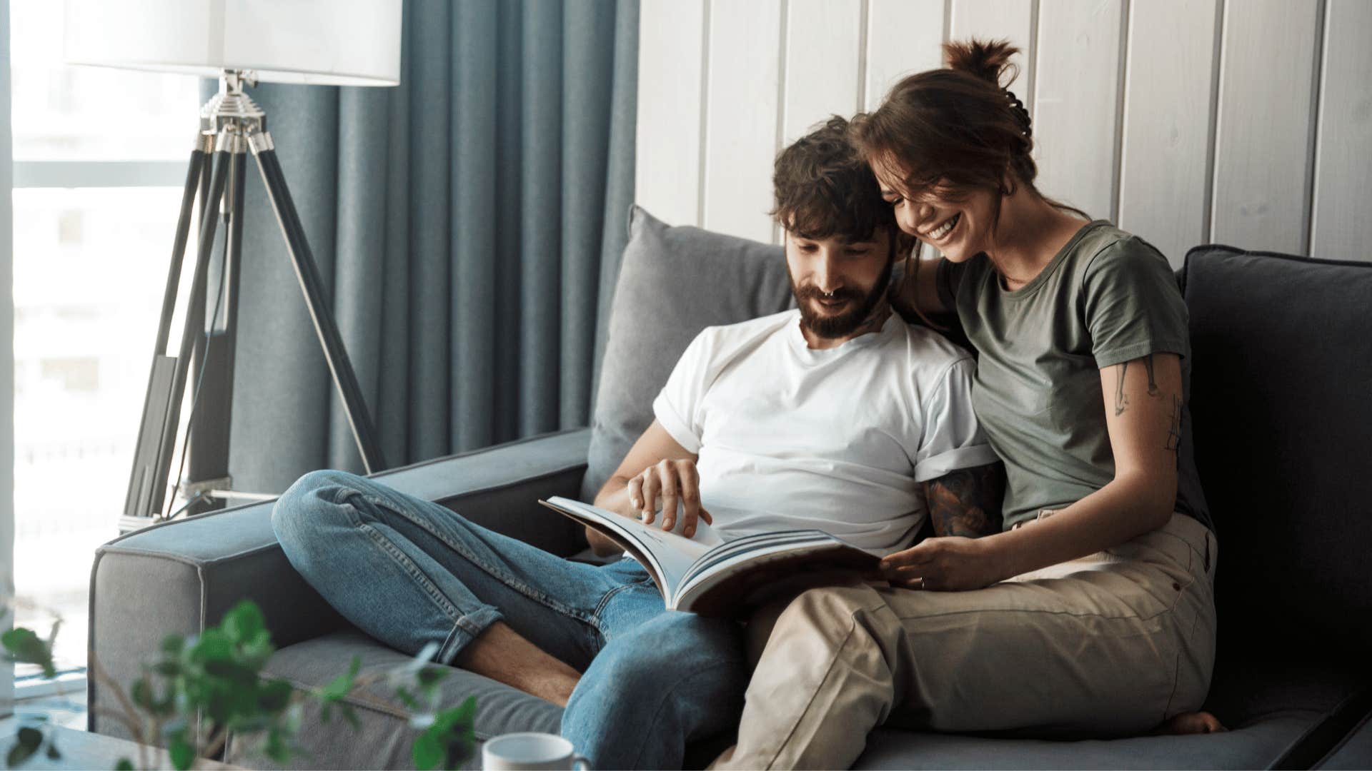 happy couple looking at a book together