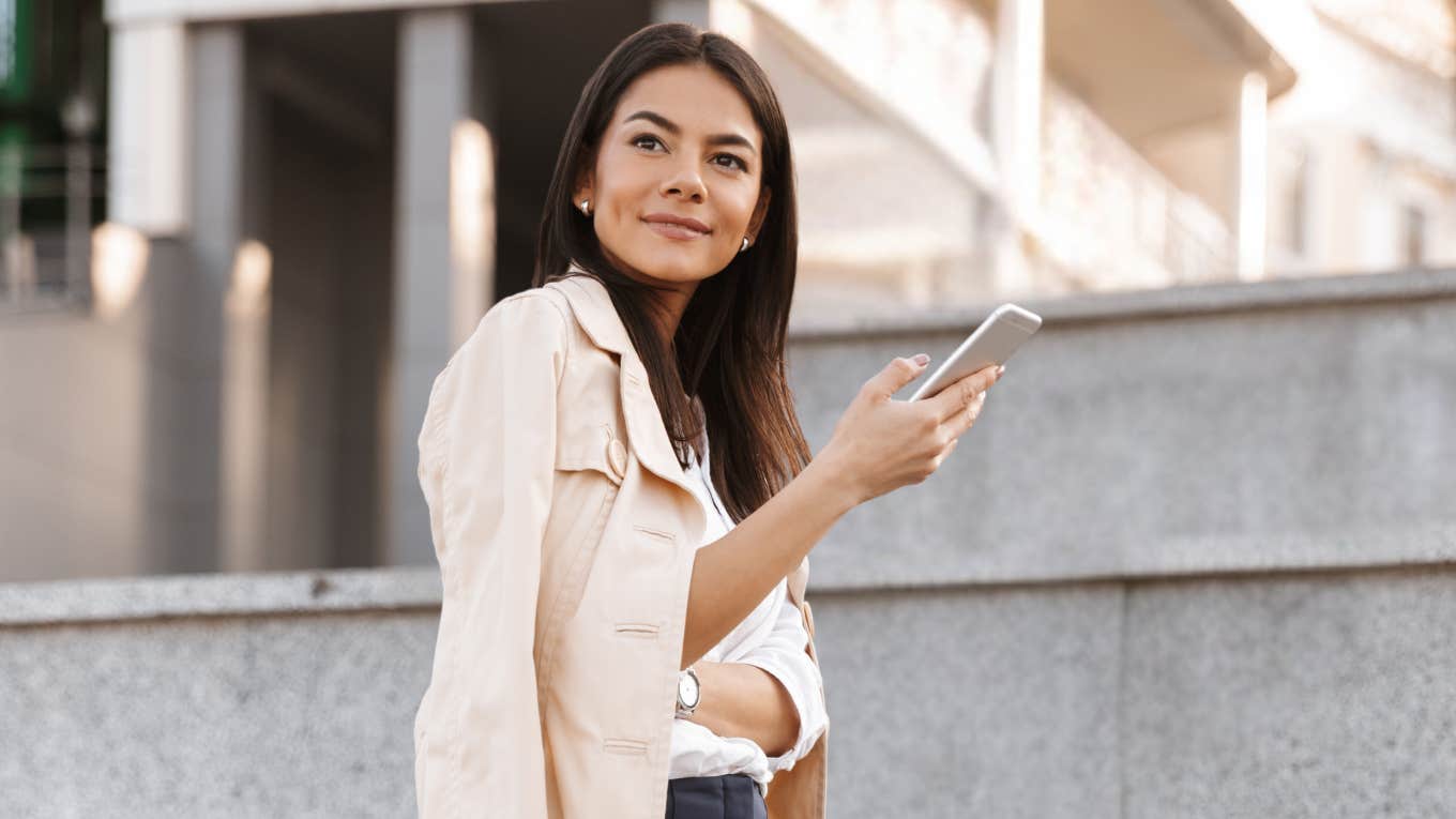 Woman being charming over text, holding phone