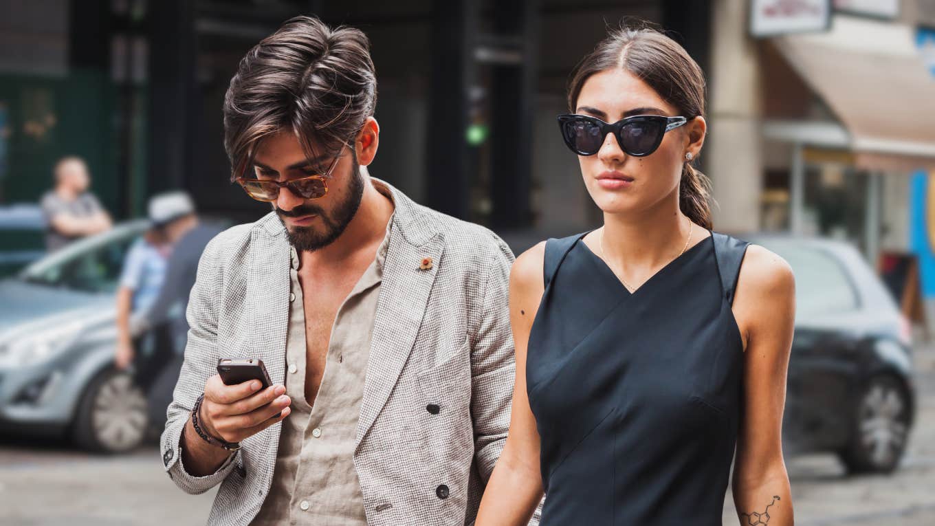 Woman walking with multi-millionaire man who ignores her