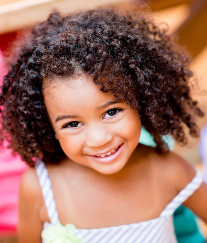 smiling little girl with curly hair