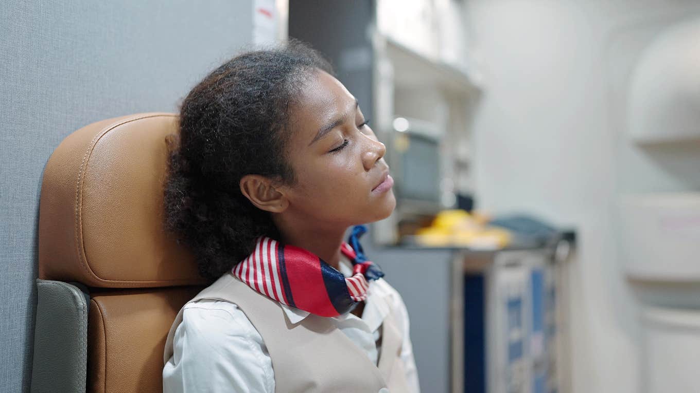 Flight attendant with eyes closed