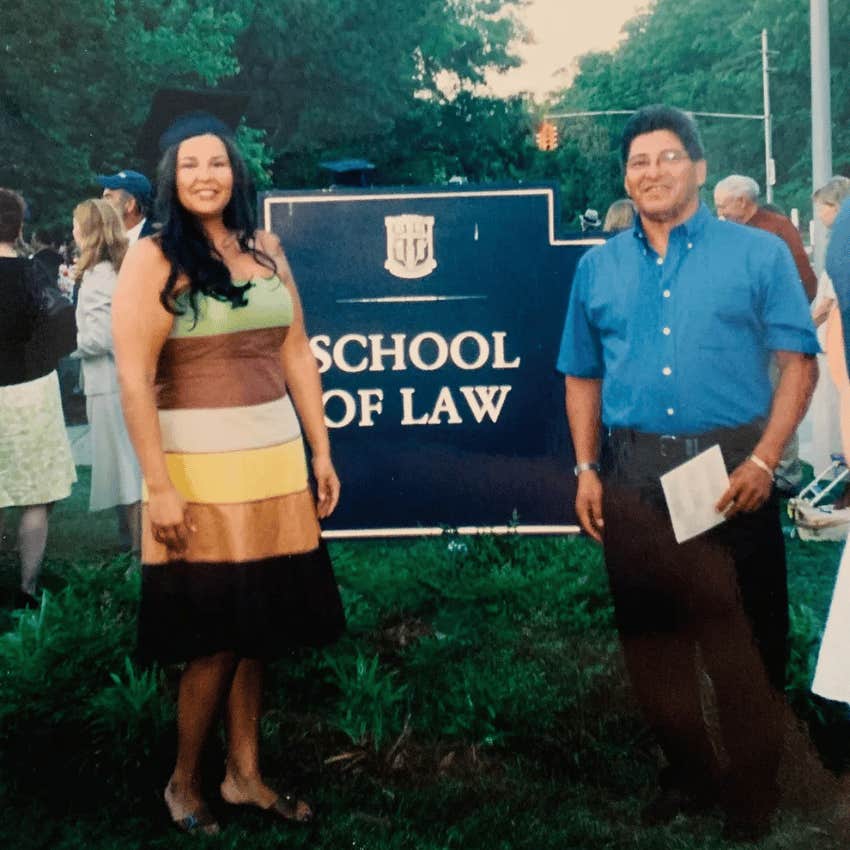 Author poses with her father at the graduation ceremony