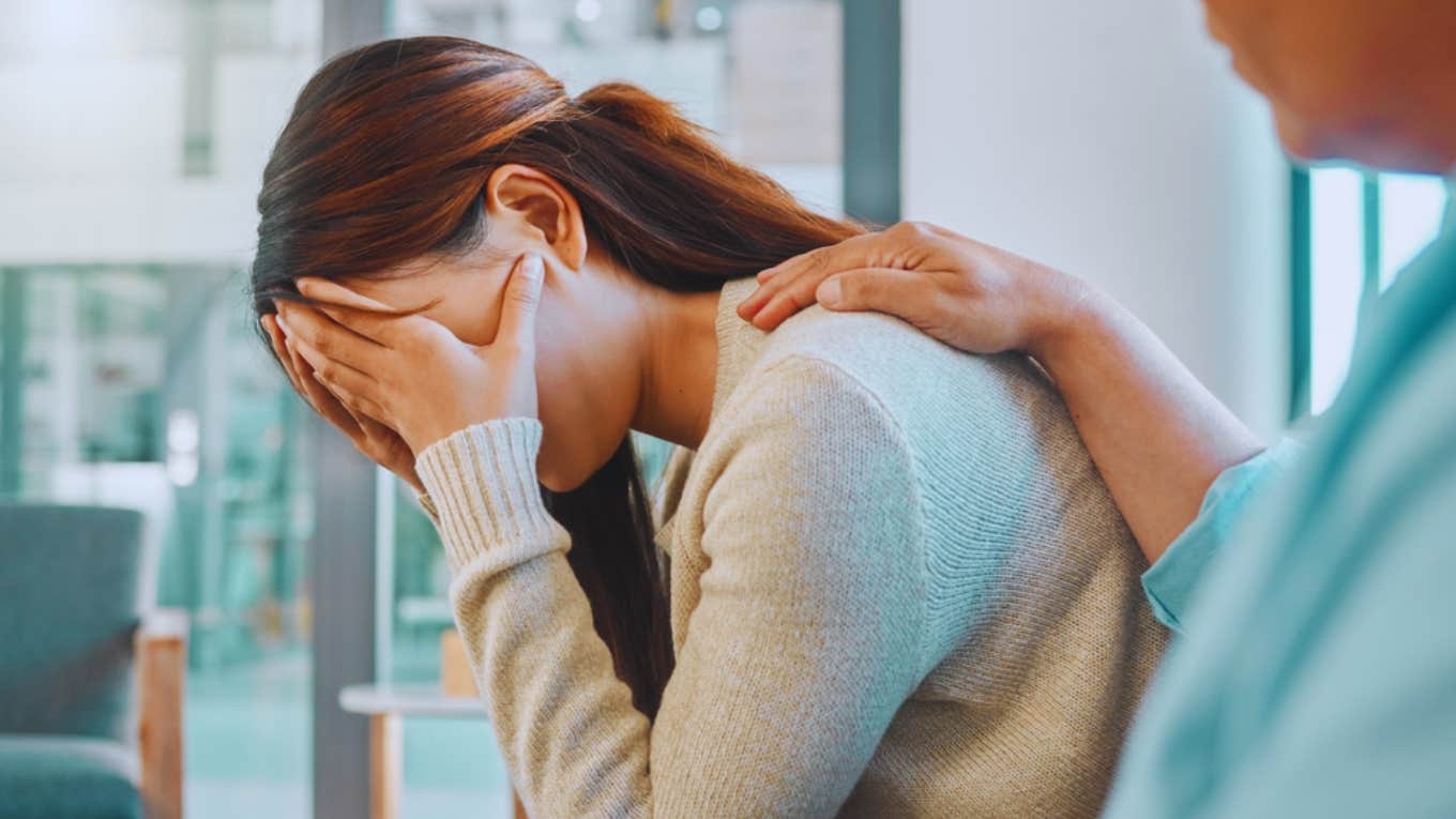 man comforting crying woman 