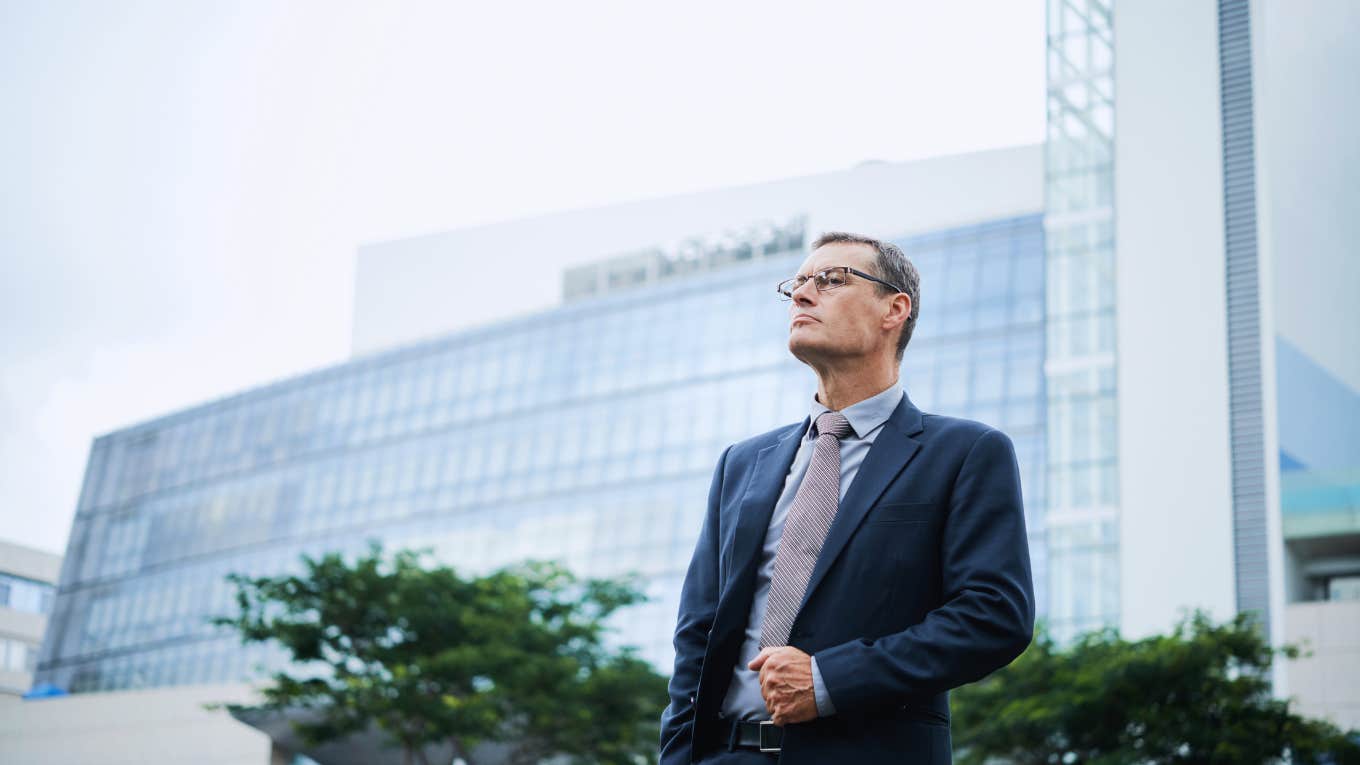 Banking executive standing in front of office building