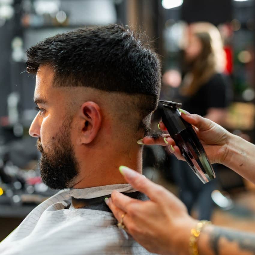 barber cutting man's hair