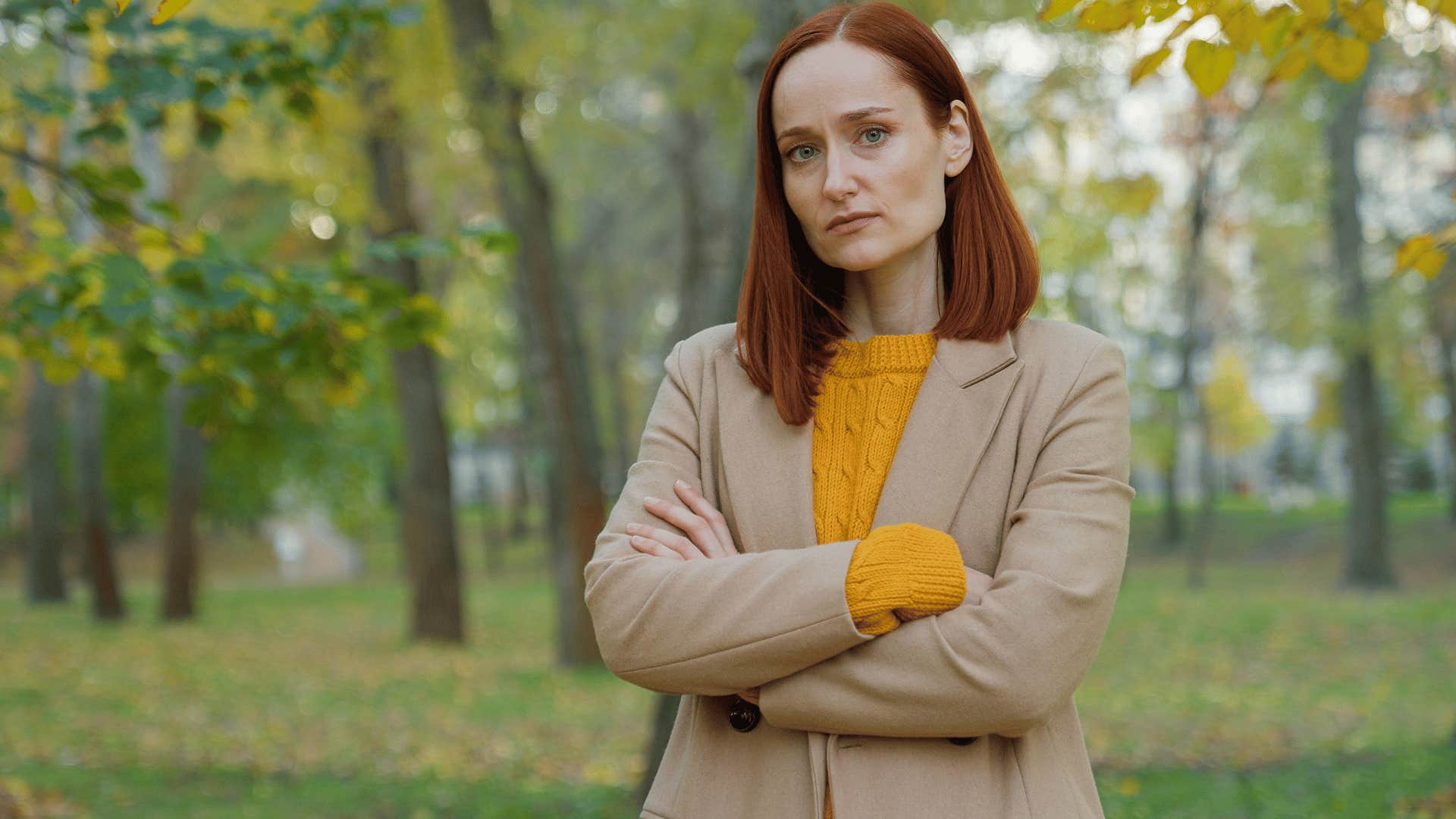 woman crossing arms while staring straight at the camera