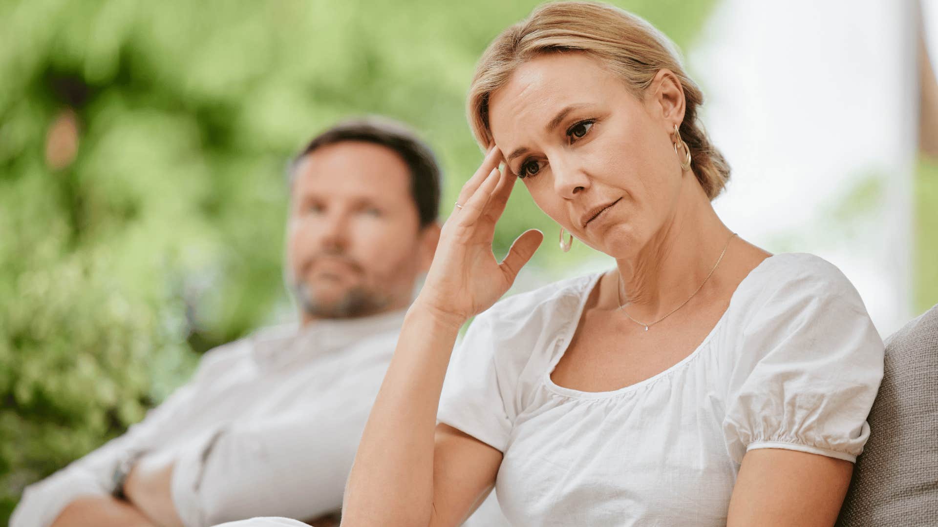 woman looking upset while man stares at her 