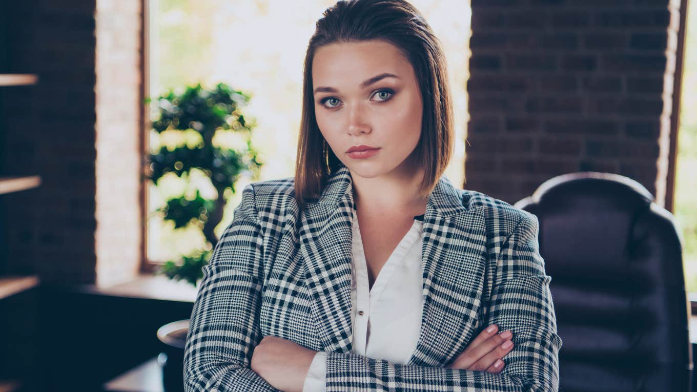 serious boss in an office with her arms crossed